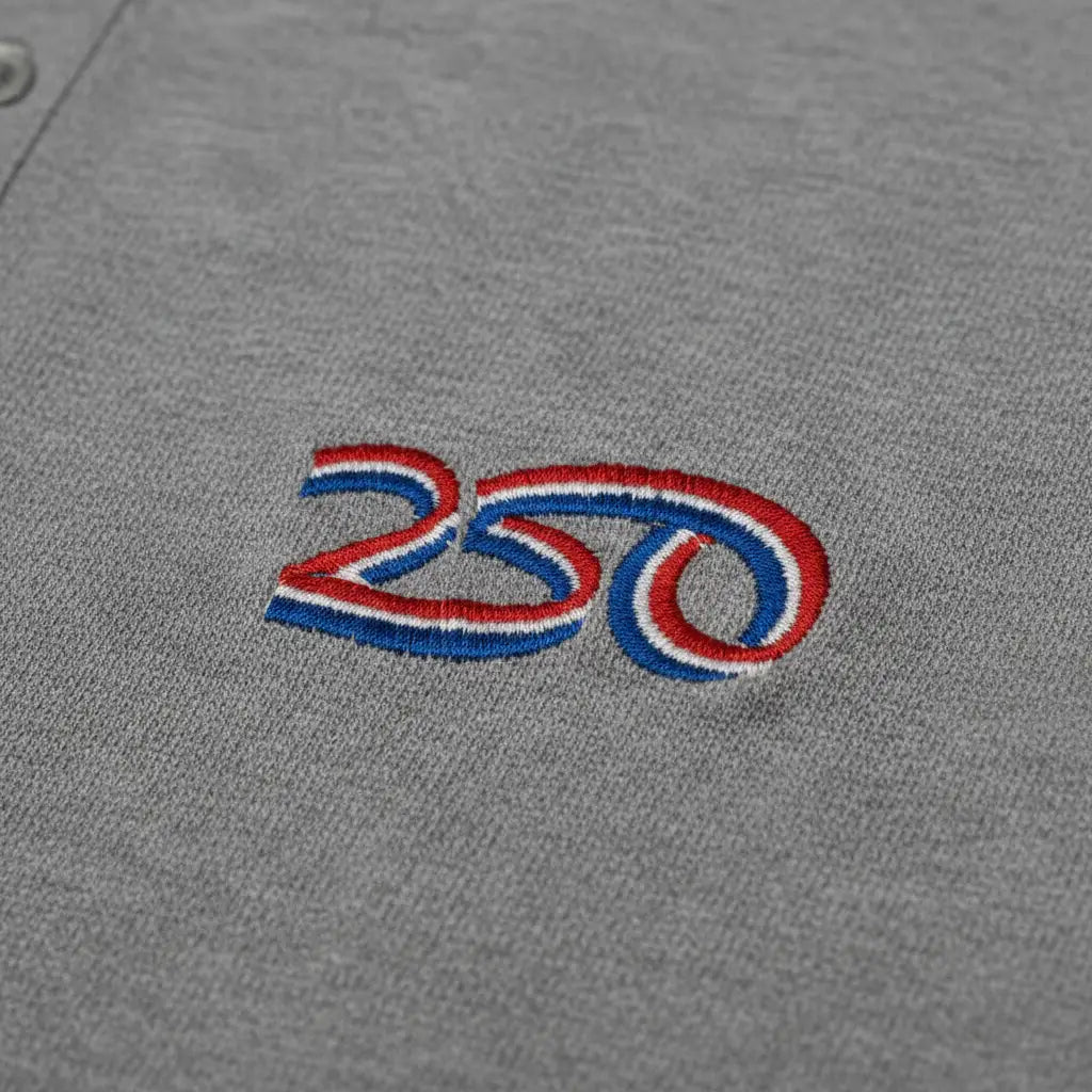 closeup of embroidered 250th Anniversary of American Independence logo on a gray polo.