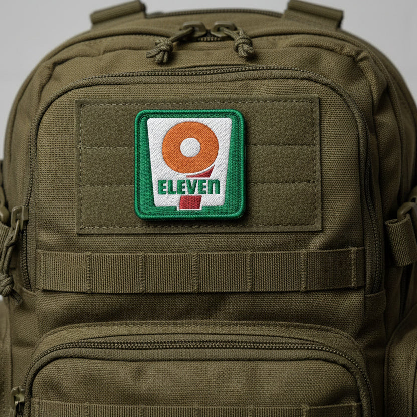 Patch with '9 Eleven' logo on a white background