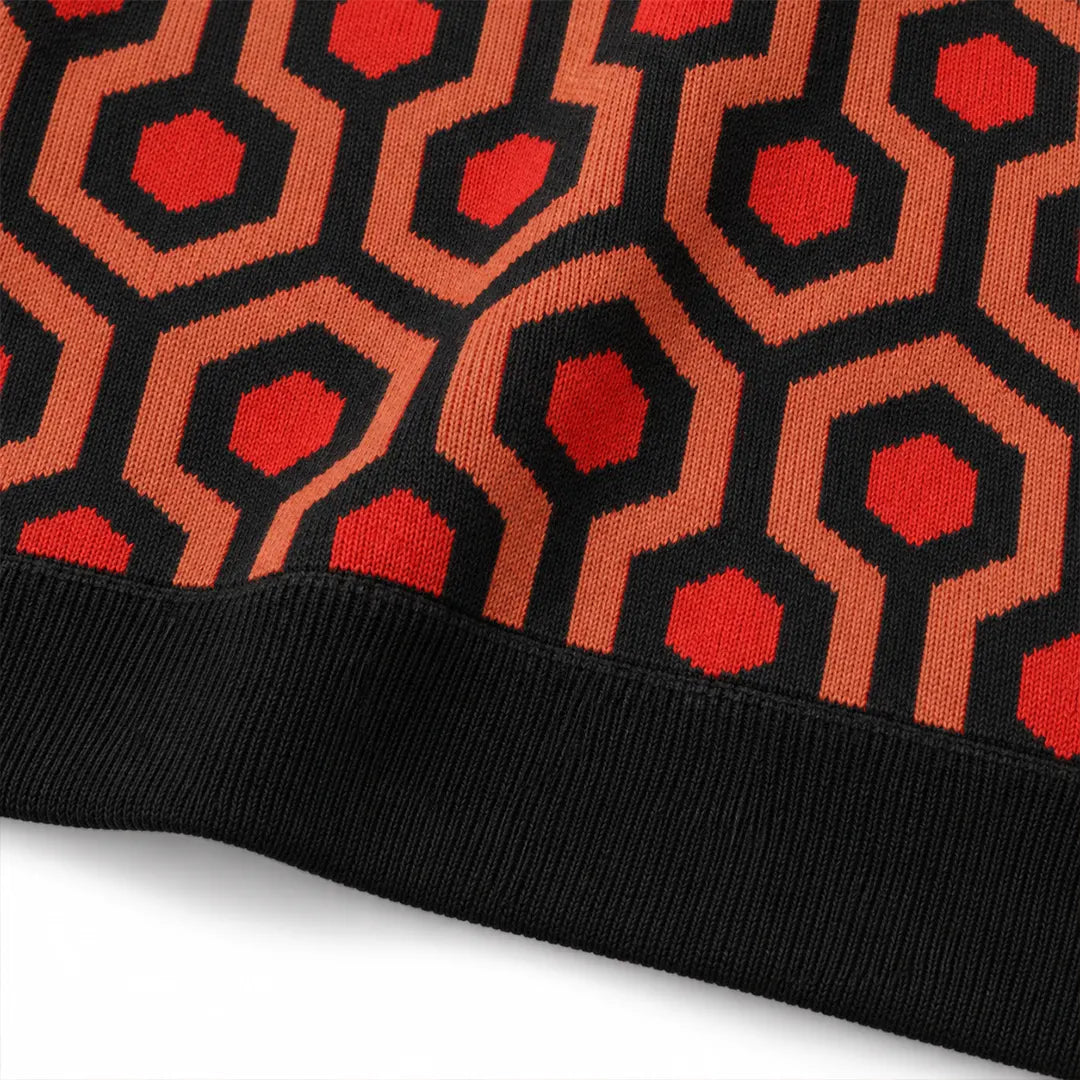 Close-up of Overlook Knit Hoodie lower hem showing geometric jacquard and black ribbed waistband