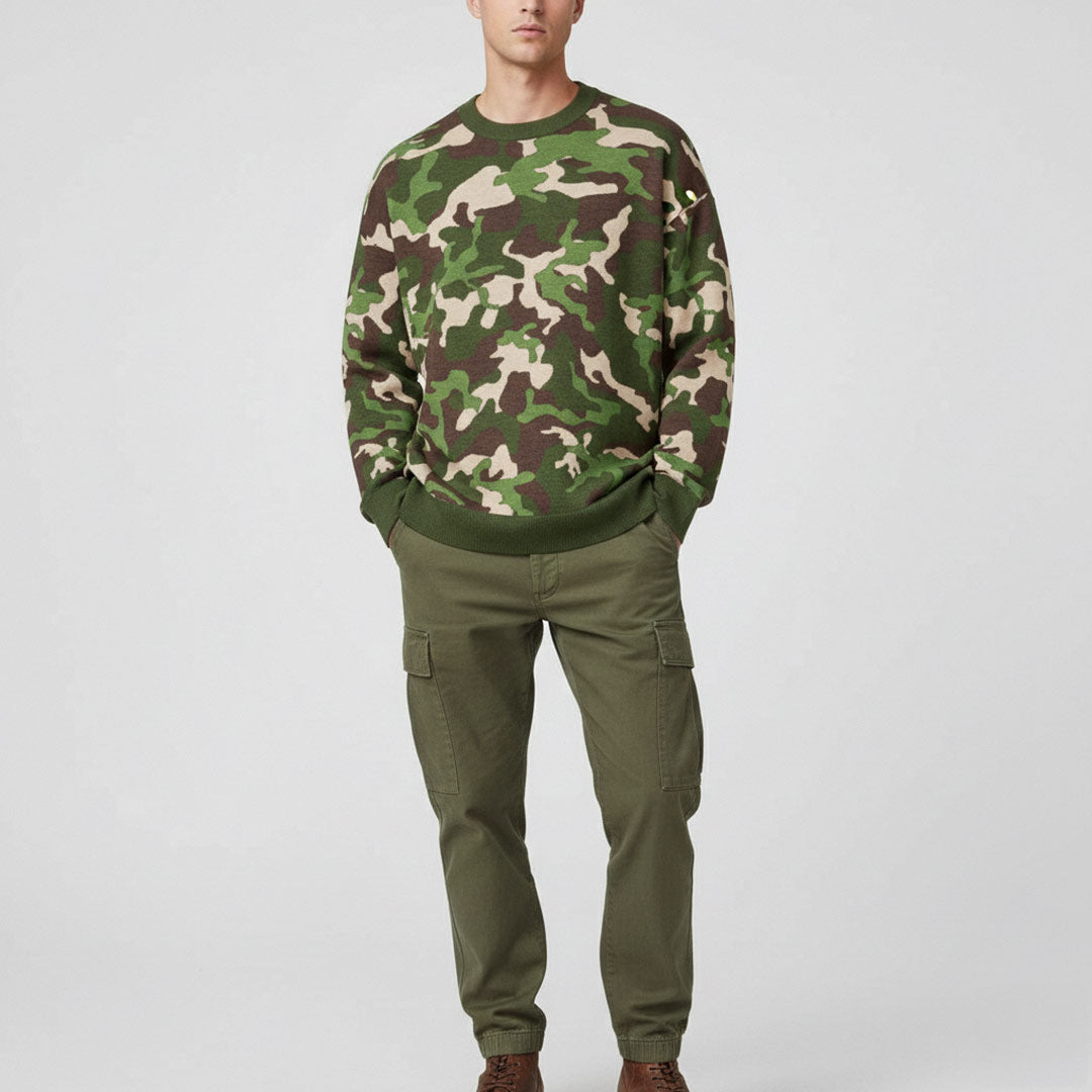 Person wearing a camouflage Liberty Maniacs Woodland Knit Field Sweater front view in green, brown, and tan camo