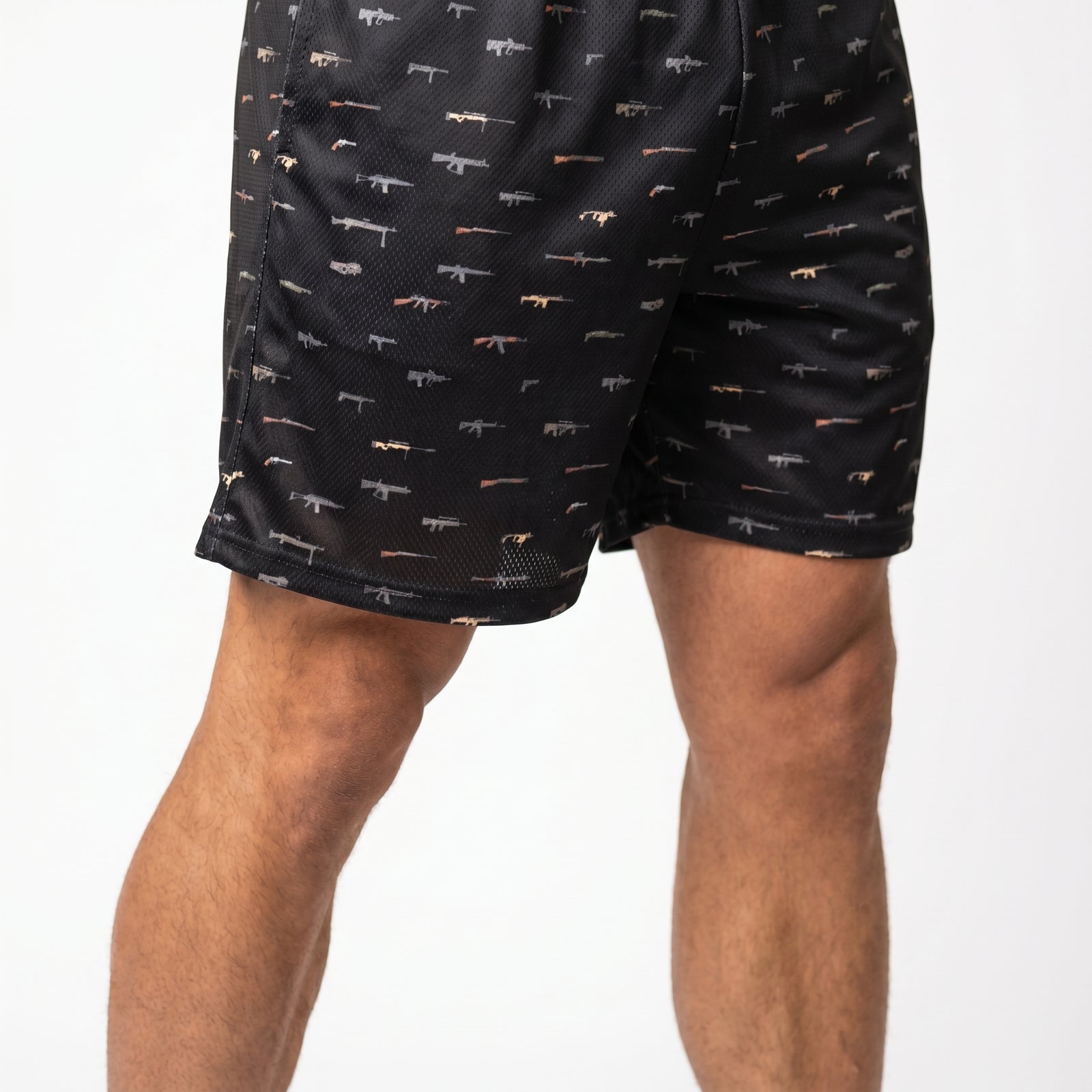 Black shorts with small patterns worn by a person on a white background