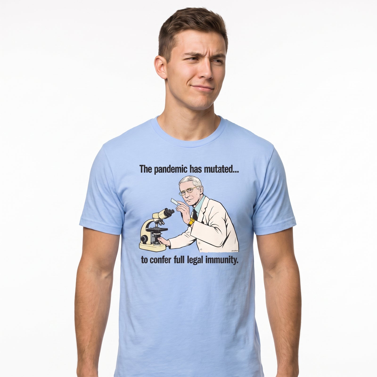 A man wearing a light blue graphic t-shirt with a cartoon illustration of a scientist looking at a microscope and the text 'The pandemic has mutated.