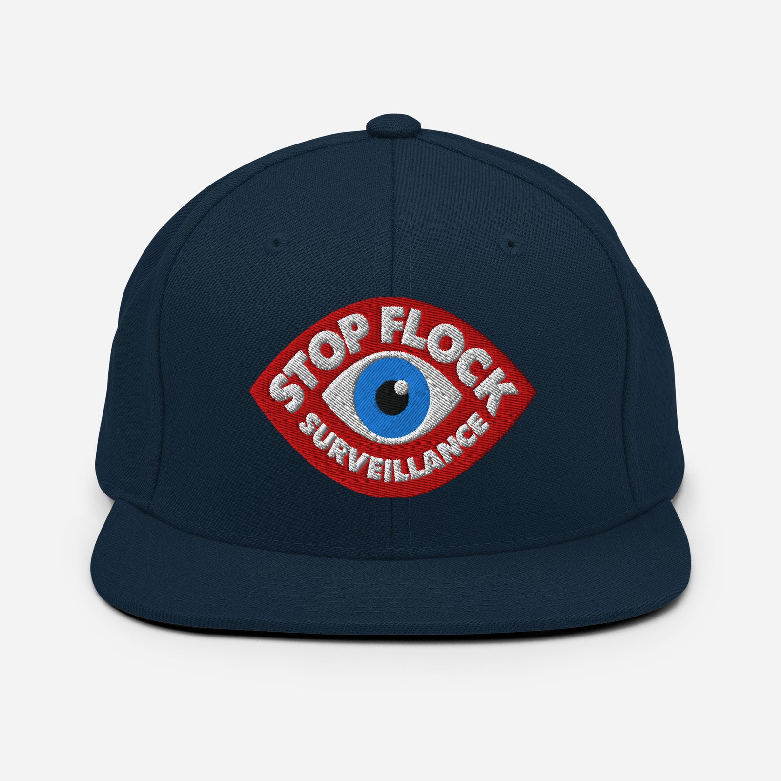 A dark navy blue flat-brim cap featuring a red, white, and blue embroidered patch on the front with the text 'STOP FLOCK SURVEILLANCE'.