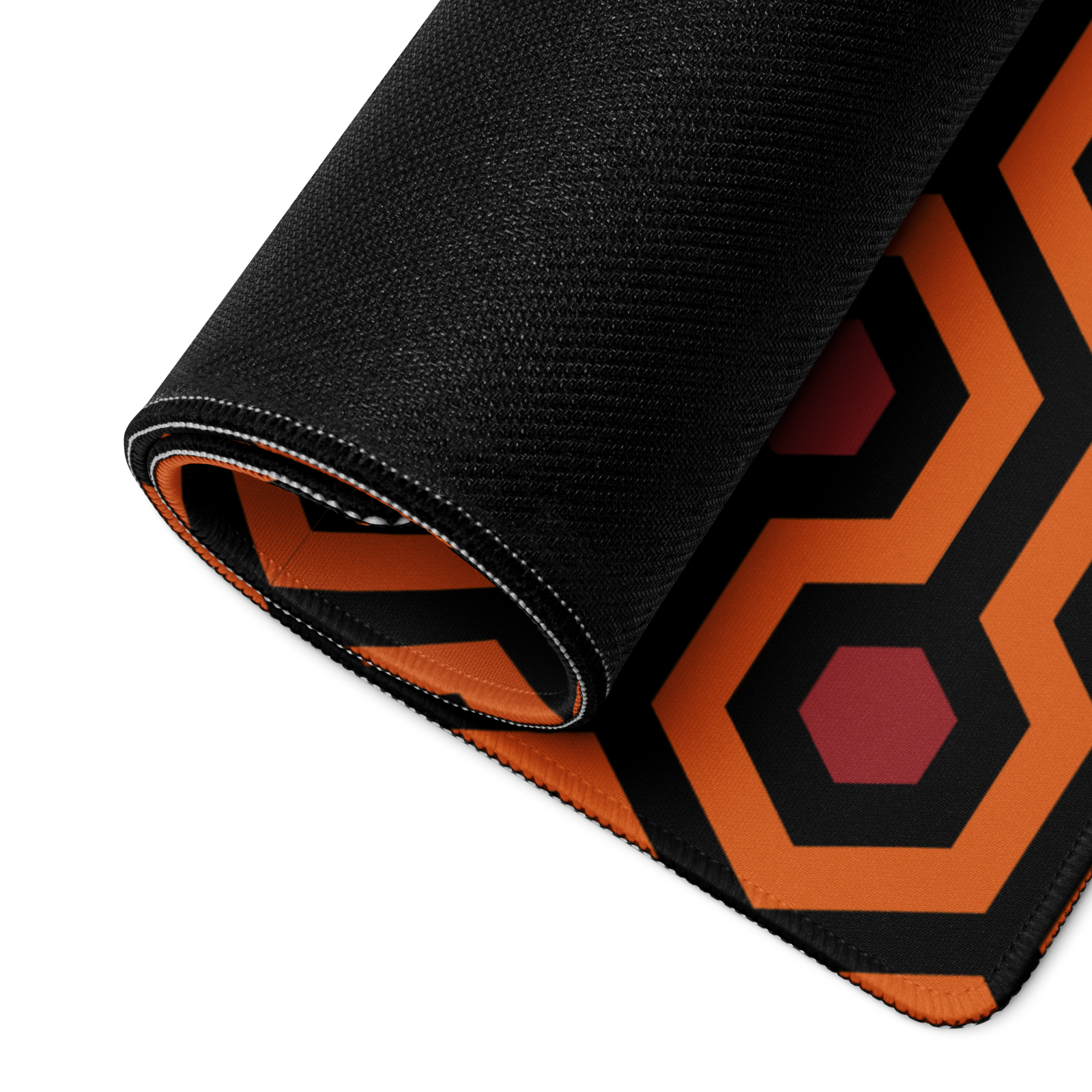 Close-up of the Overlook carpet desk mat showing its stitched edge, printed surface, and rubber base