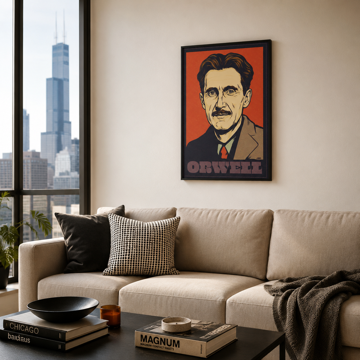 Living room with a framed portrait of George Orwell on the wall, a beige sofa, and cityscape view.