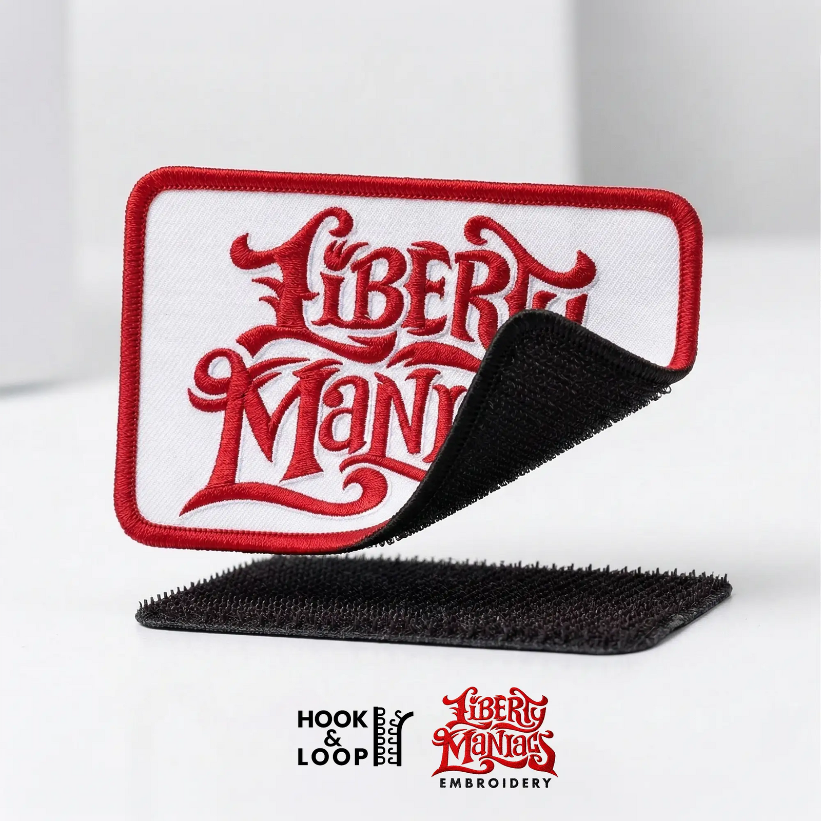 Embroidered patch with 'Liberty Maniacs' design on a white background