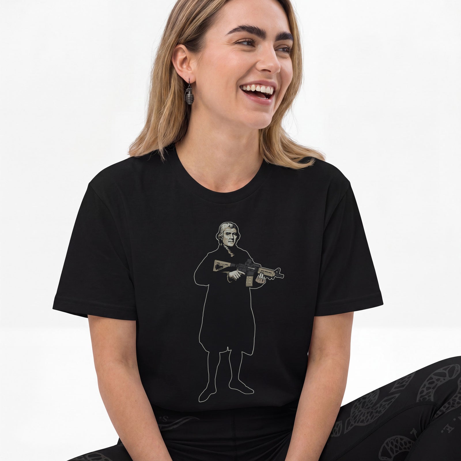 Woman wearing a Thomas Jefferson With a Carbine T-Shirt by Liberty Maniacs on a white background