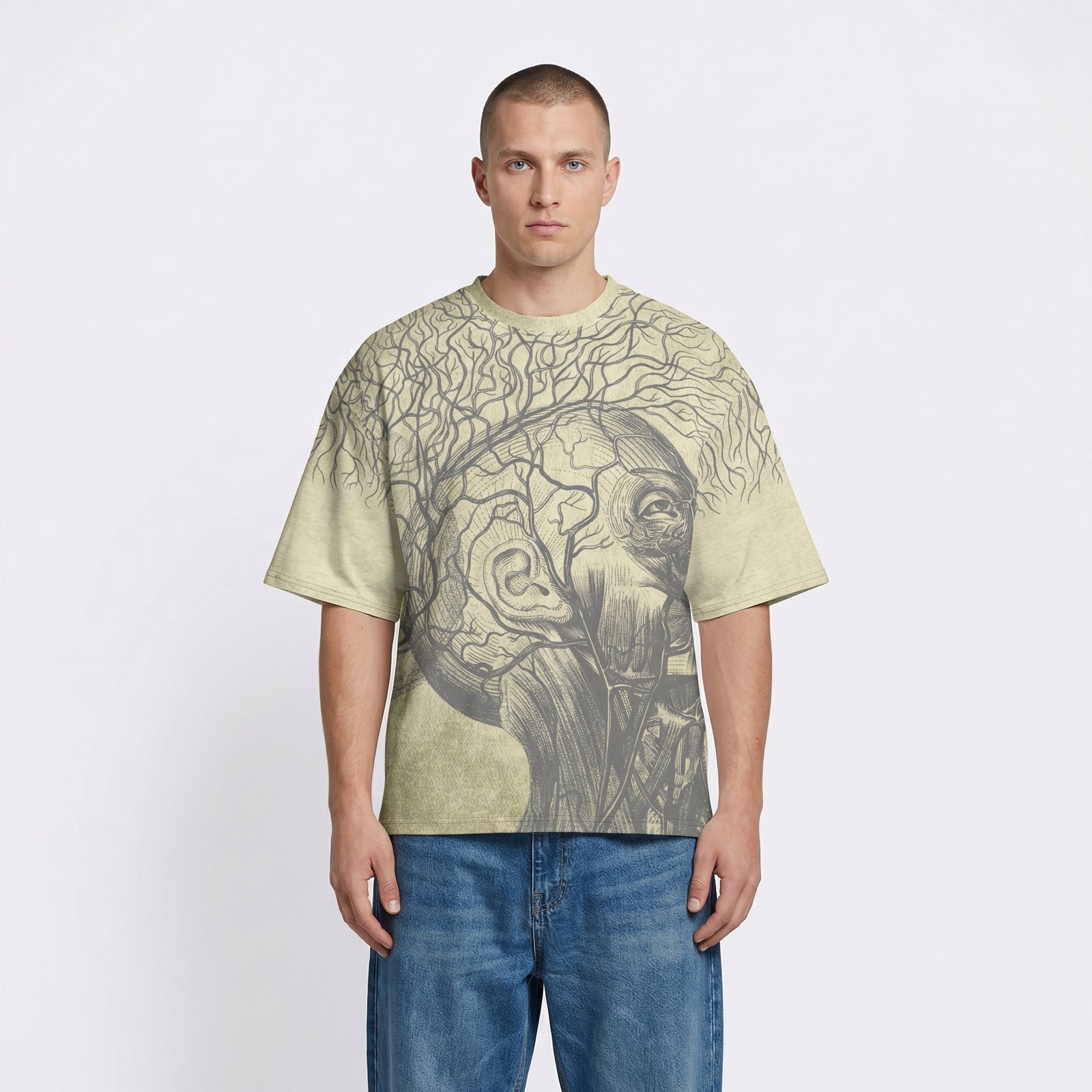 Man wearing a light green t-shirt with a graphic design on a plain background