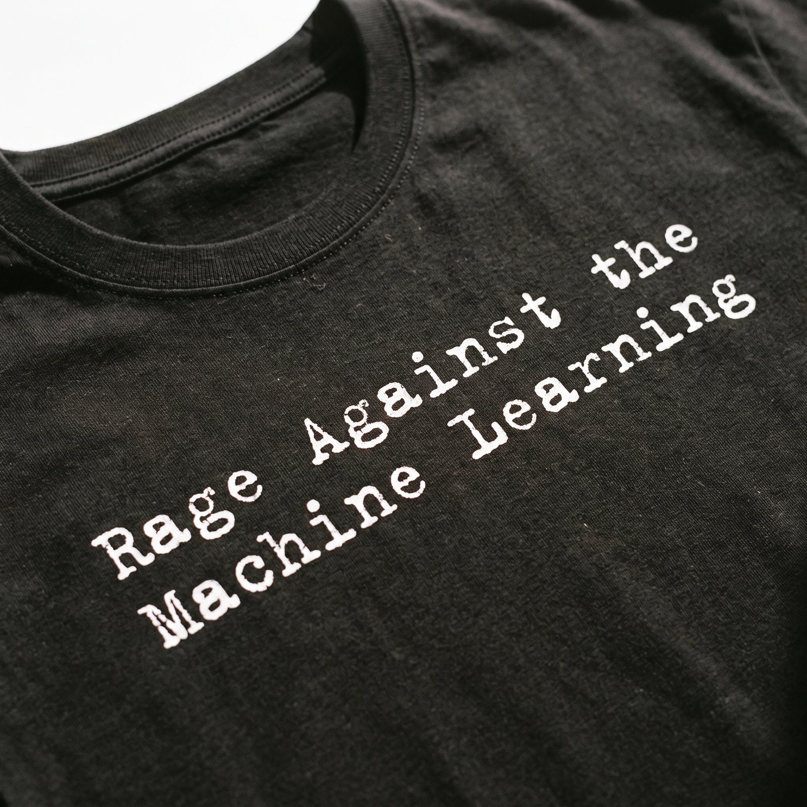 Close-up of the white typewriter-style Rage Against the Machine Learning print