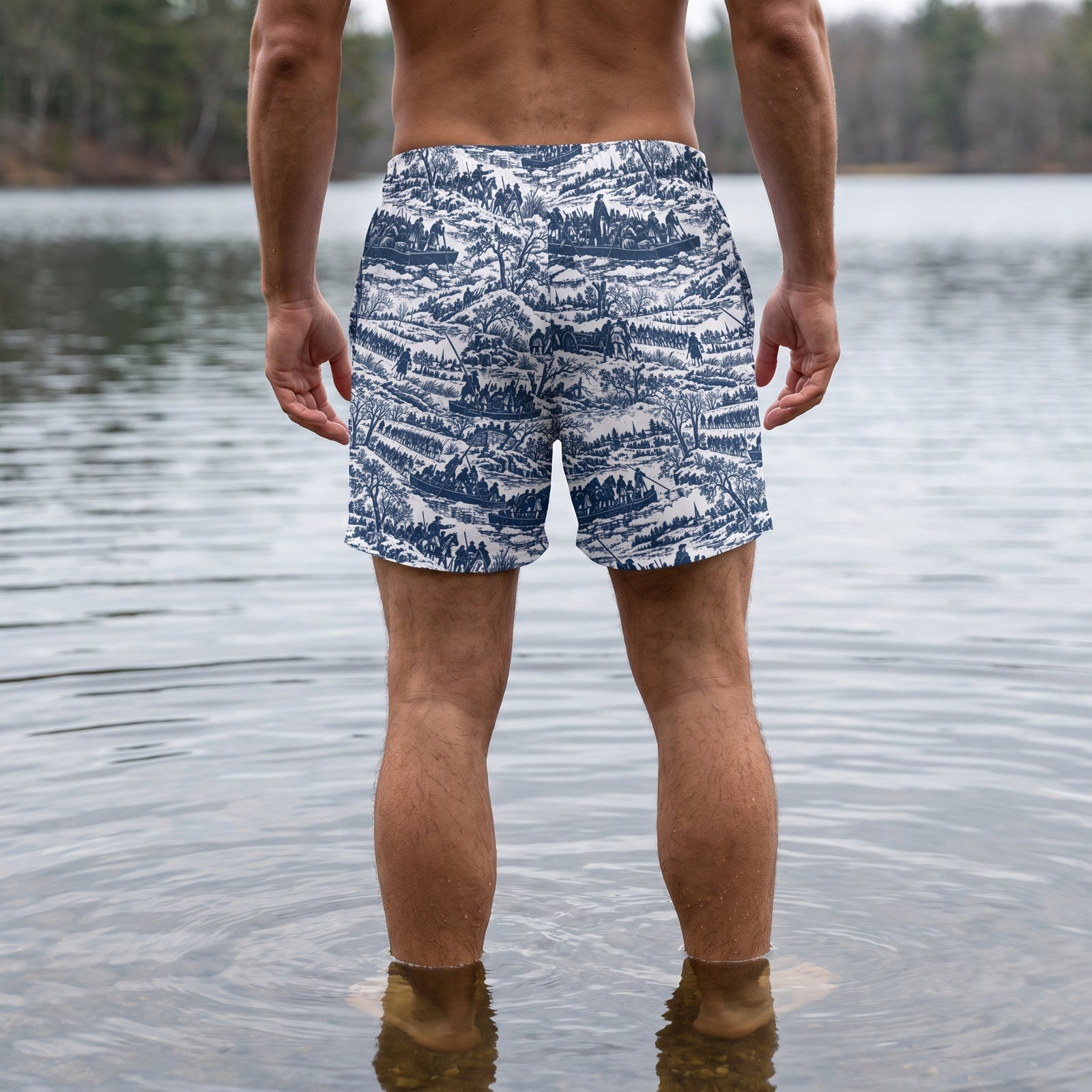 Back view of a man wearing Washington Crossing the Delaware historical swim trunks in shallow water