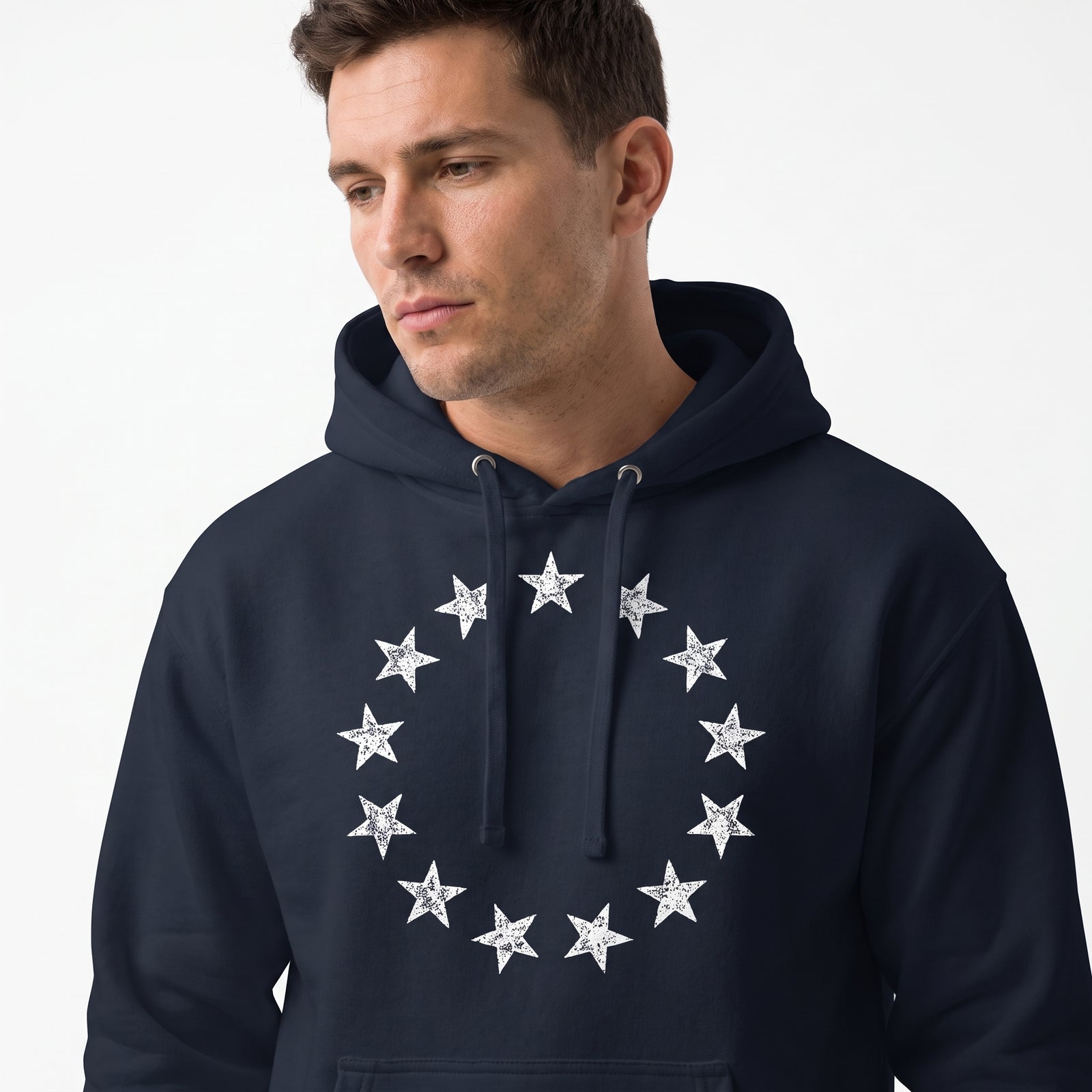 Studio portrait of a man in the navy 13 Stars Vintage Revolution Heritage Hoodie with vintage thirteen-star chest graphic.