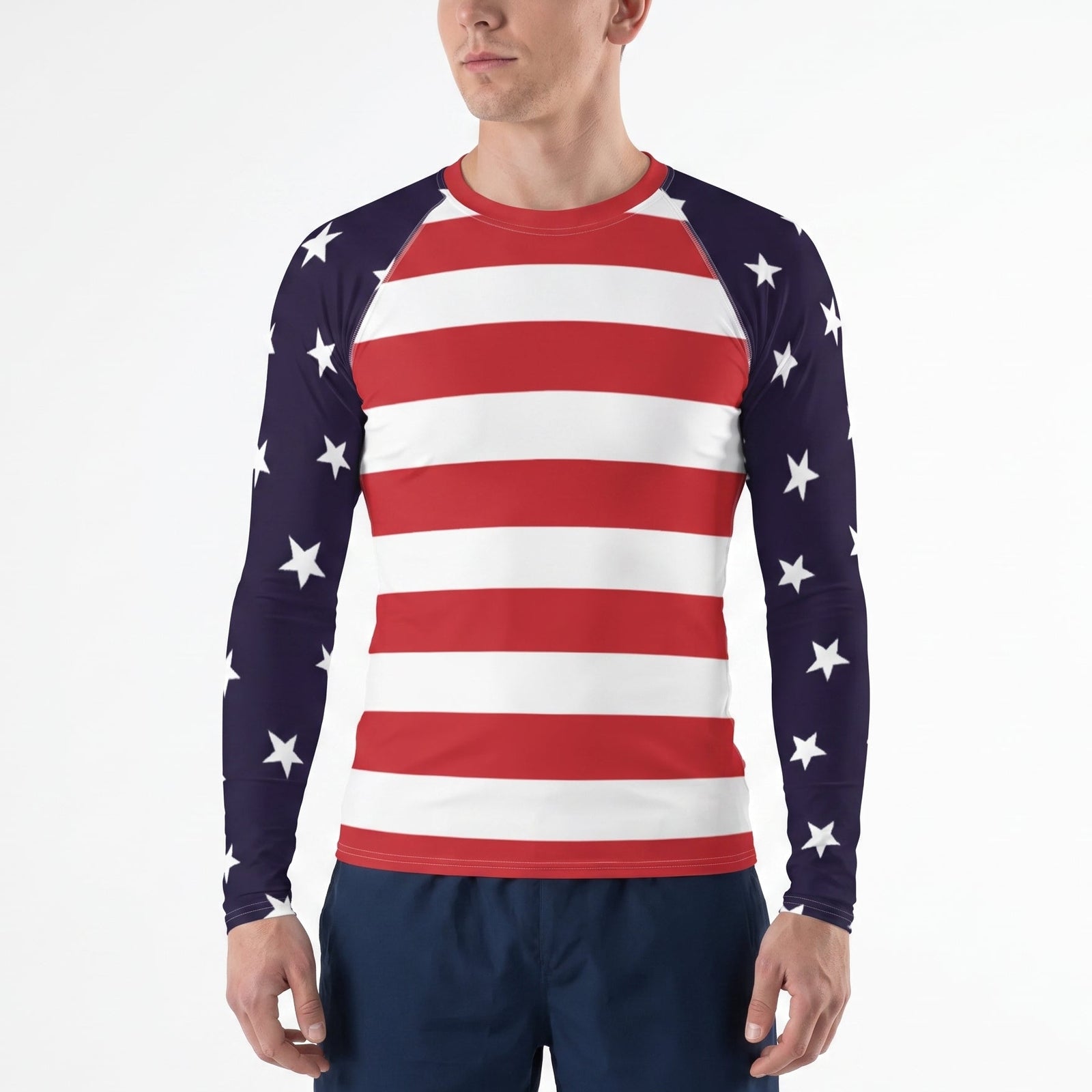 A man wearing a long-sleeve athletic shirt with an American flag pattern, featuring red and white horizontal stripes on the torso and navy sleeves with white stars, paired with navy shorts, against a plain white background.