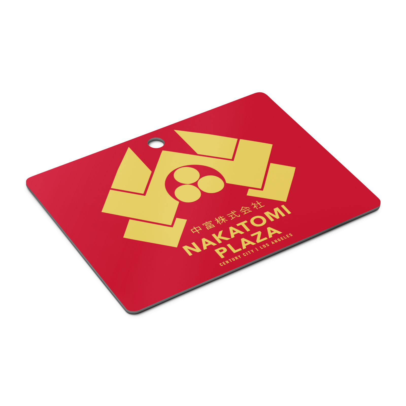 Red metal ornament with Nakatomi Plaza logo and text on a white background