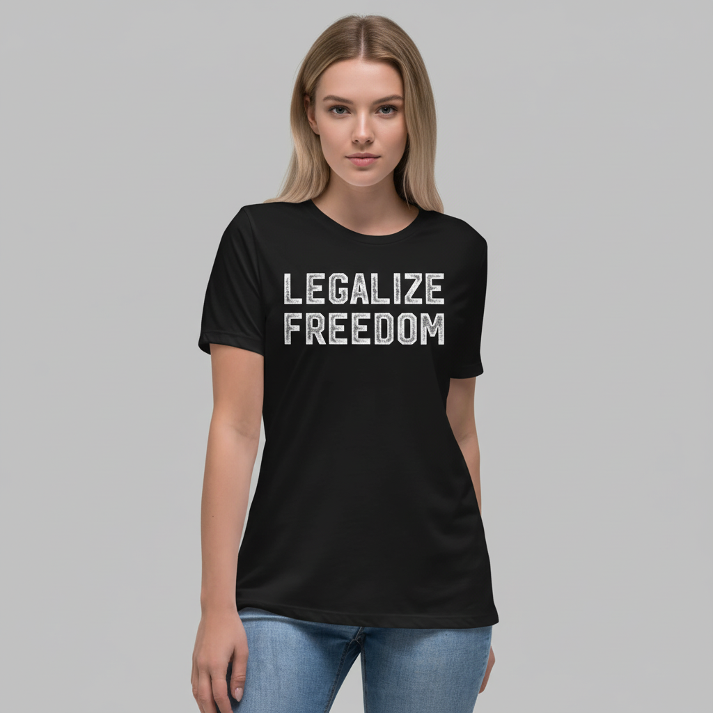 Woman wearing a black t-shirt with 'LEGALIZE FREEDOM' text on a plain background by Liberty Maniacs