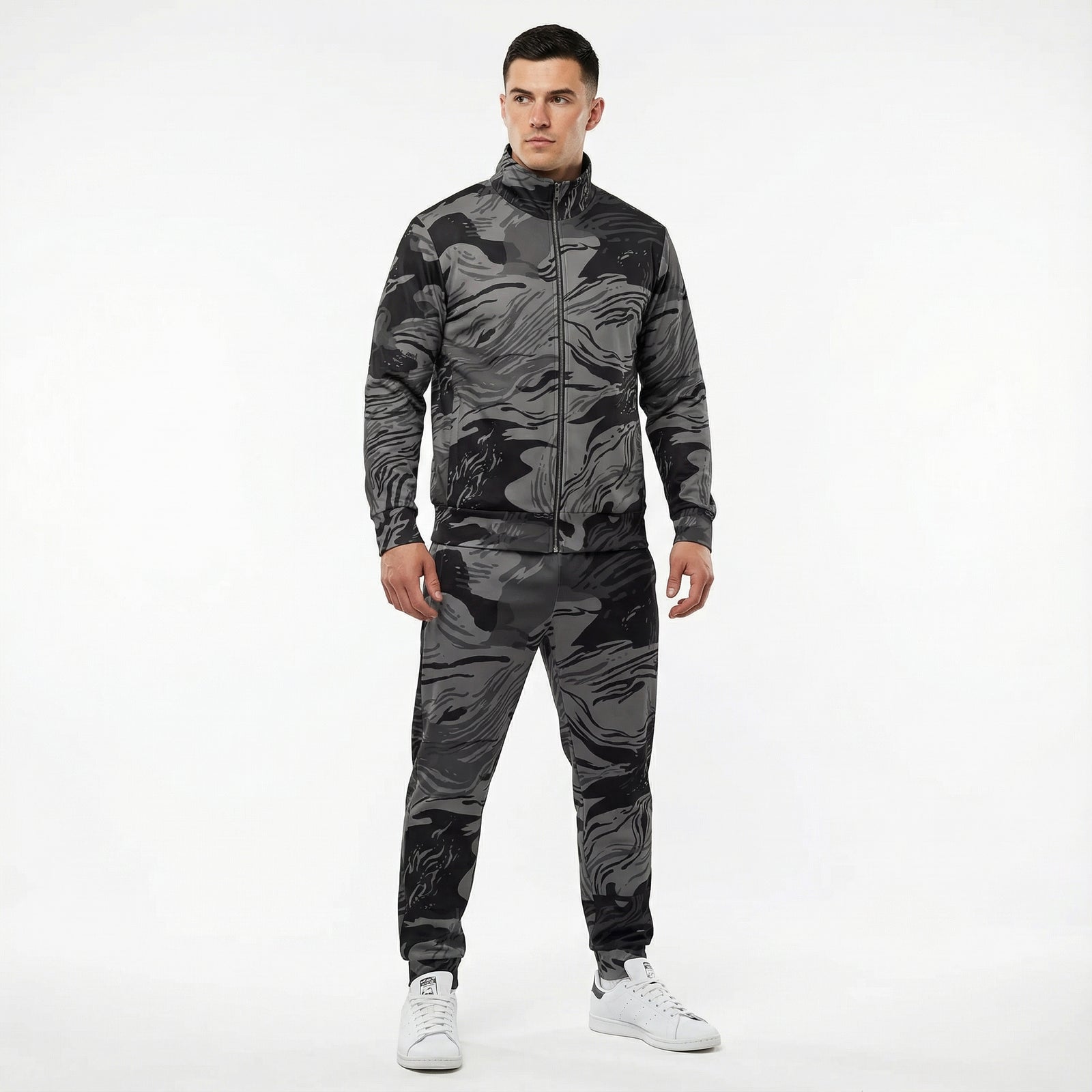 Man wearing a camouflage tracksuit on a white background