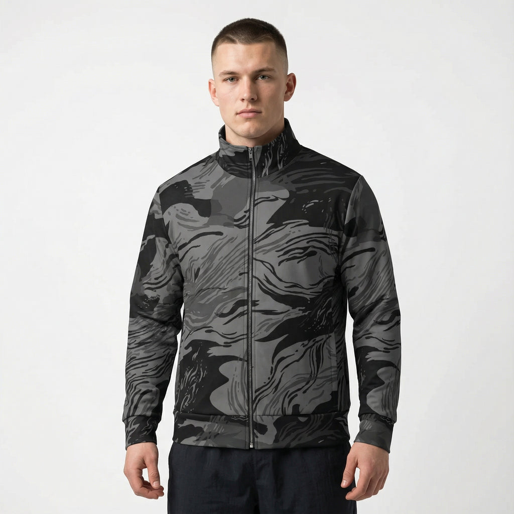 Man wearing a black and gray camouflage jacket on a white background