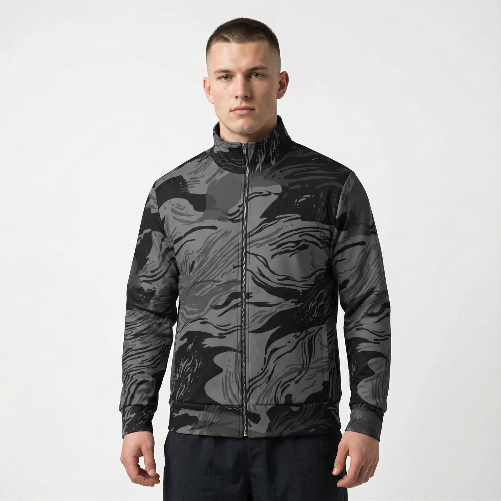 Man wearing a black and gray camouflage jacket on a white background