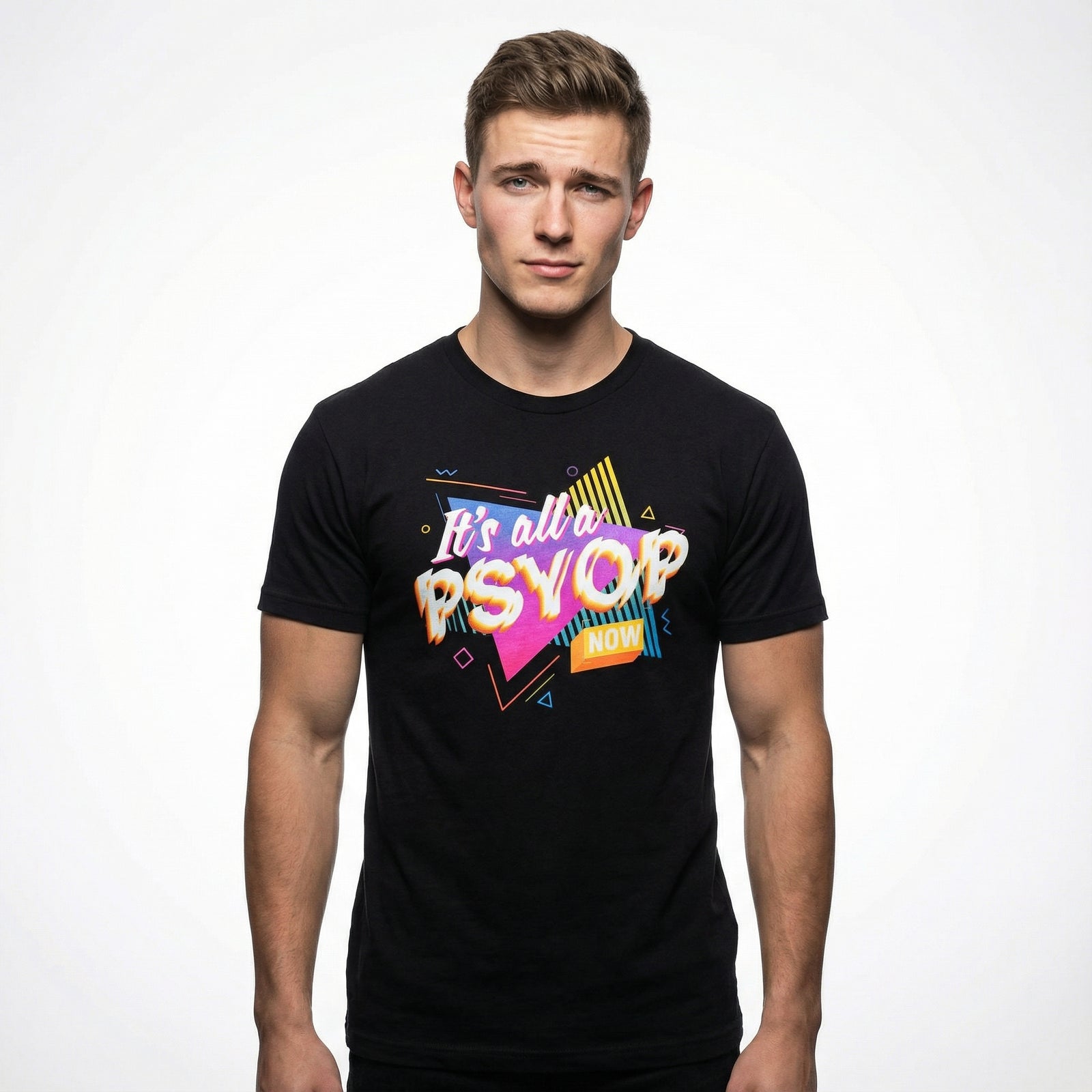 Man wearing a black t-shirt with colorful retro text saying "It's all a Psyop Now" on a white background