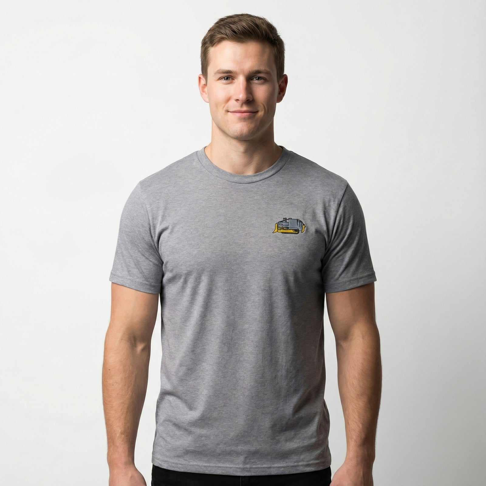 Man wearing a gray t-shirt with a small embroidered Killdozer logo on a white background