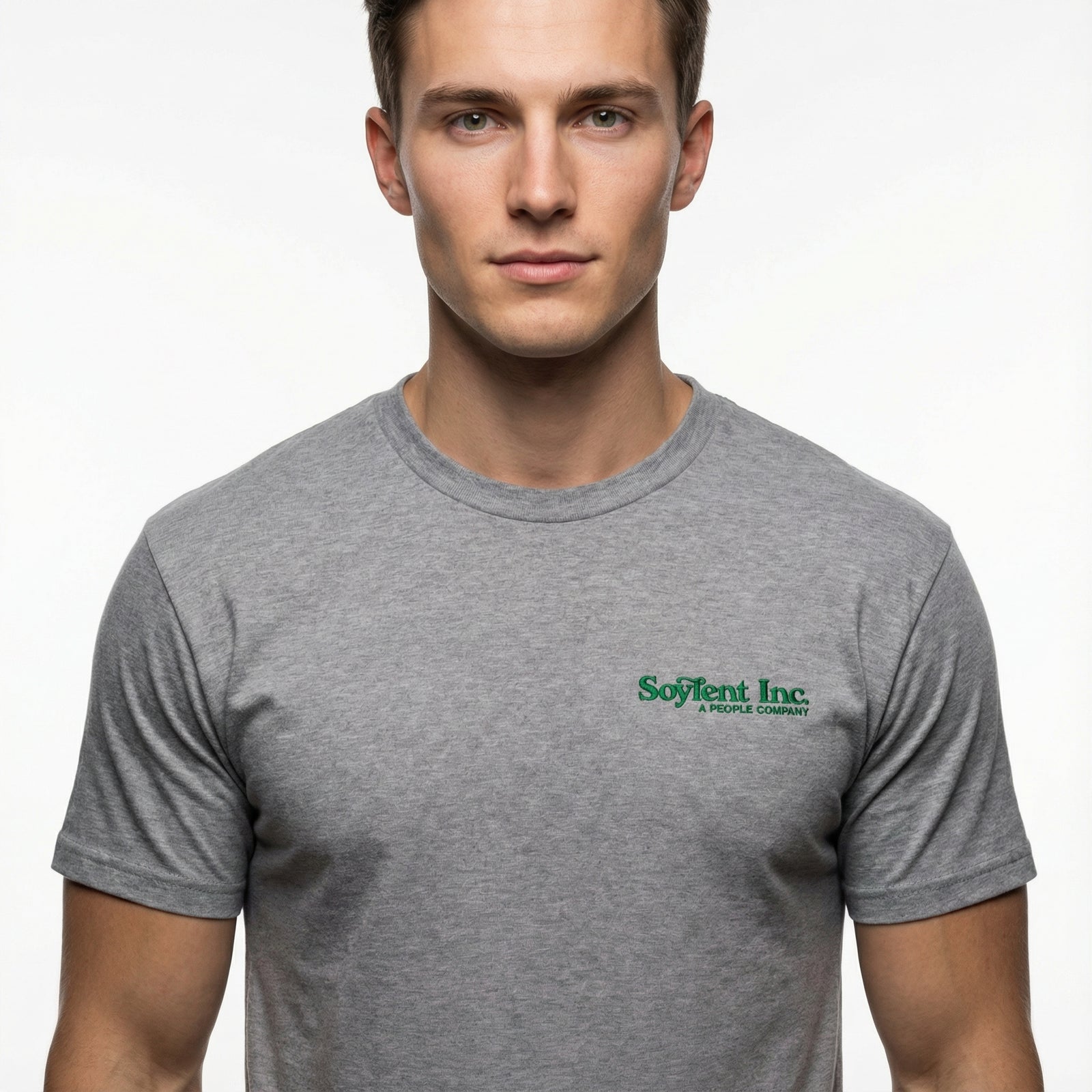 Man wearing a gray t-shirt with a logo on a plain background