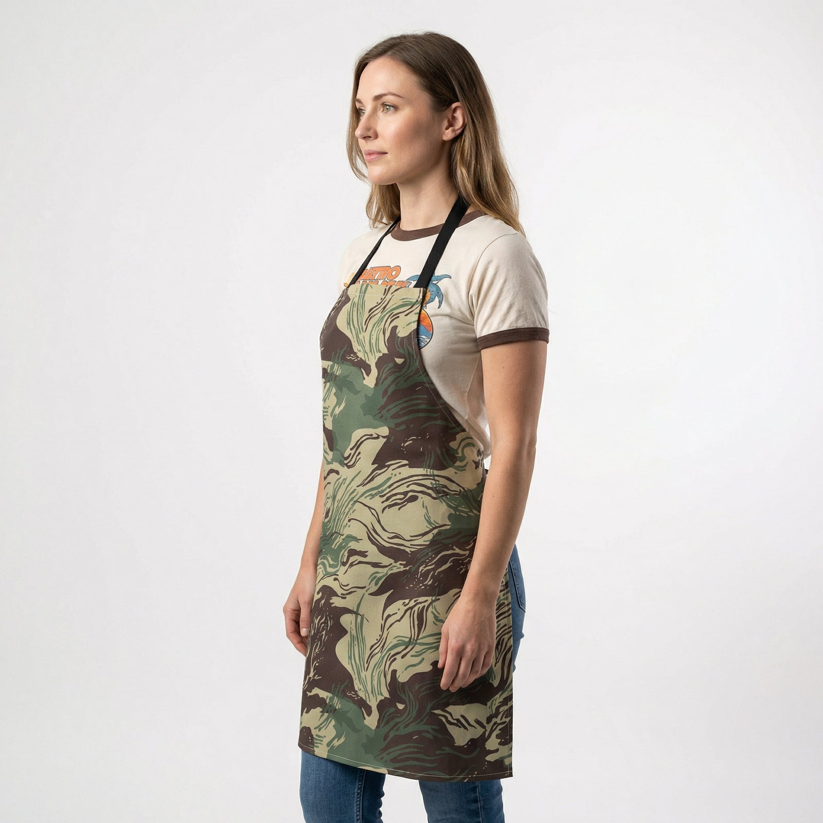 Woman wearing a camouflage apron on a white background