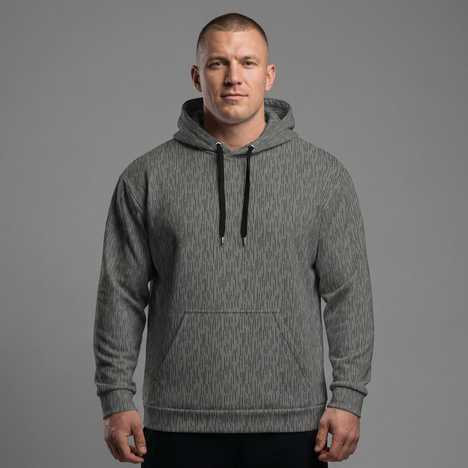 Man wearing a gray hoodie against a gray background