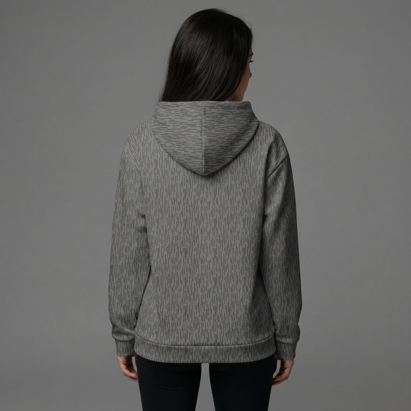 Person wearing a gray hoodie from behind on a gray background
