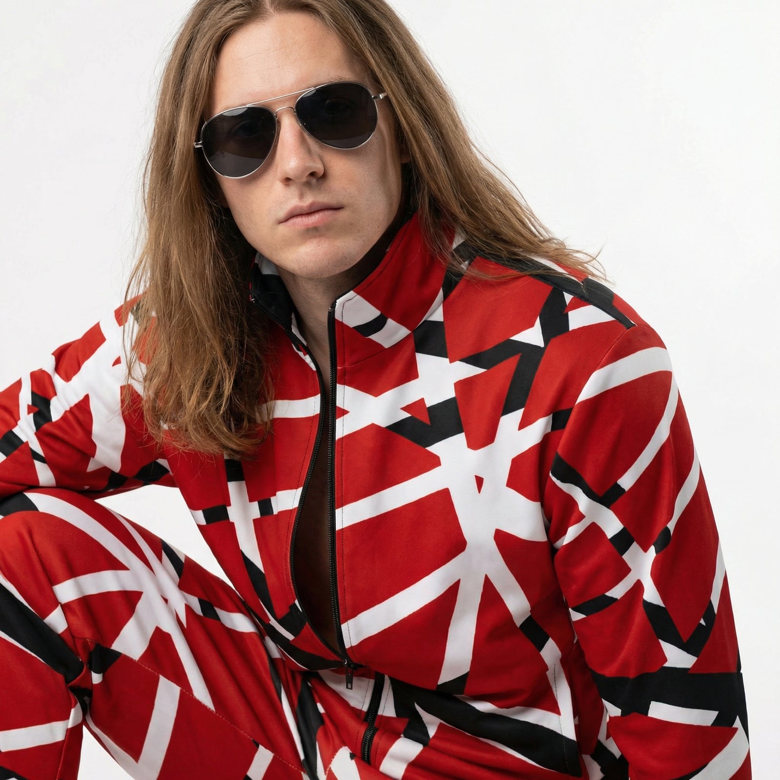 Person wearing a red and white patterned outfit with sunglasses on a white background