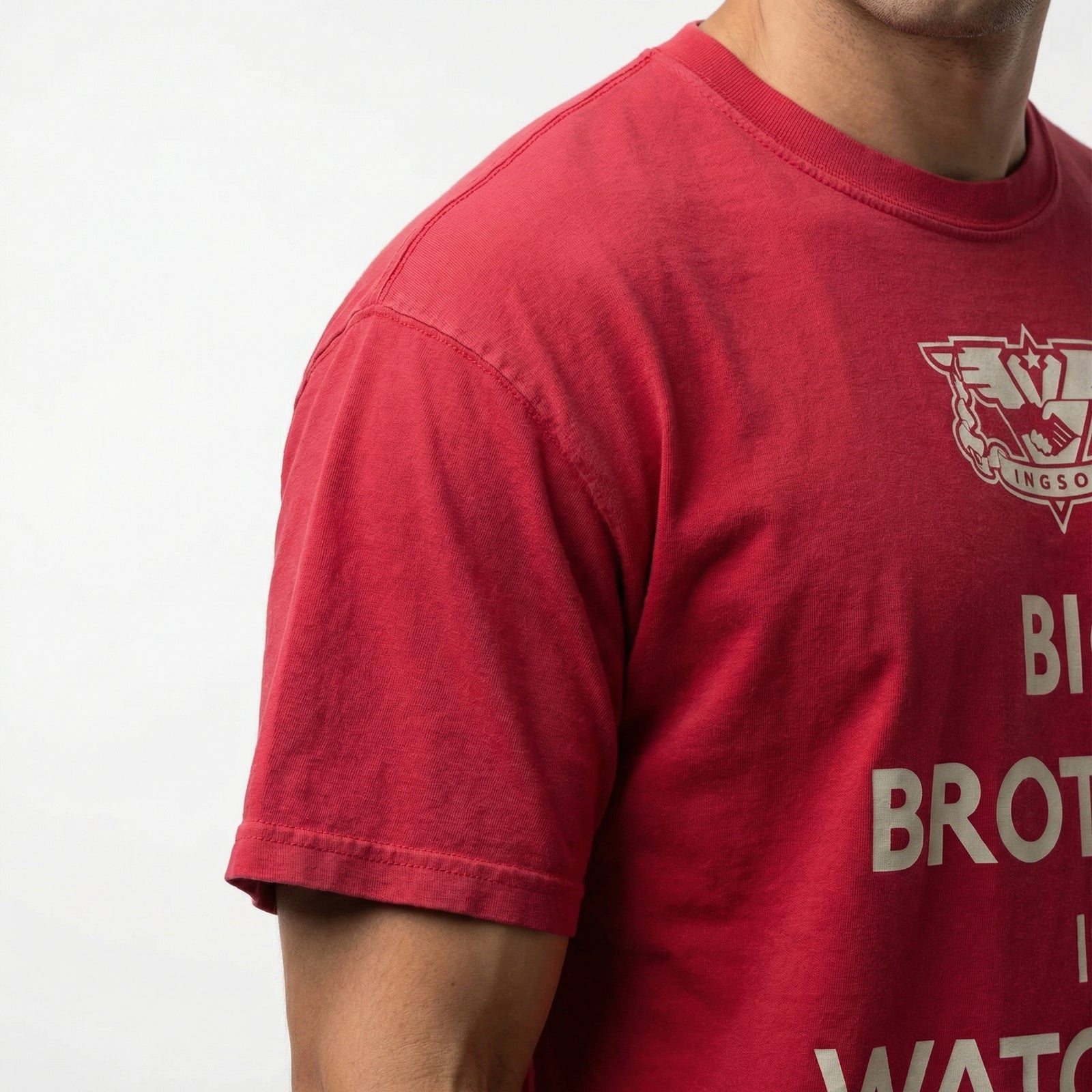 Red t-shirt with text and logo on a plain background