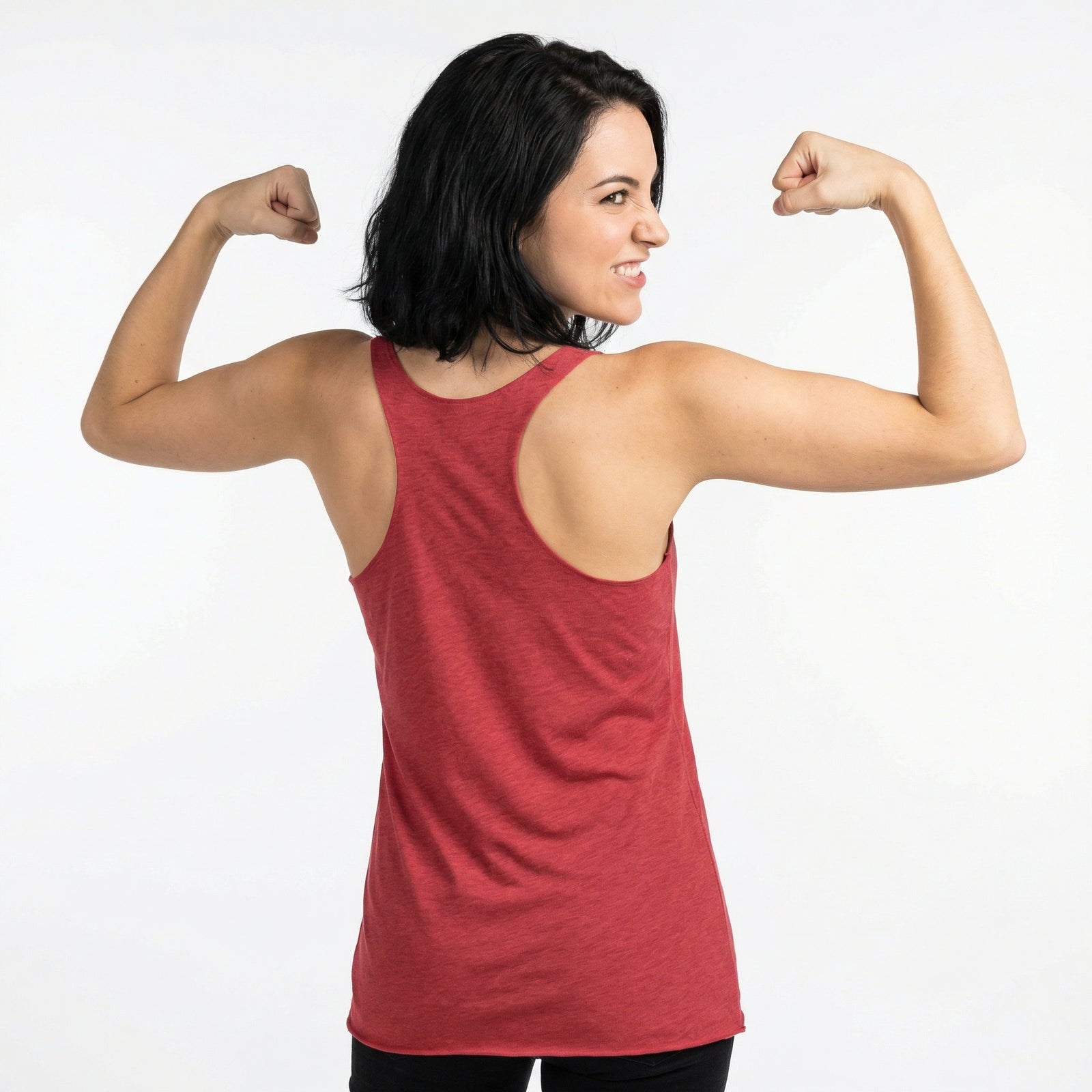 Woman in a red tank top flexing her muscles on a white background