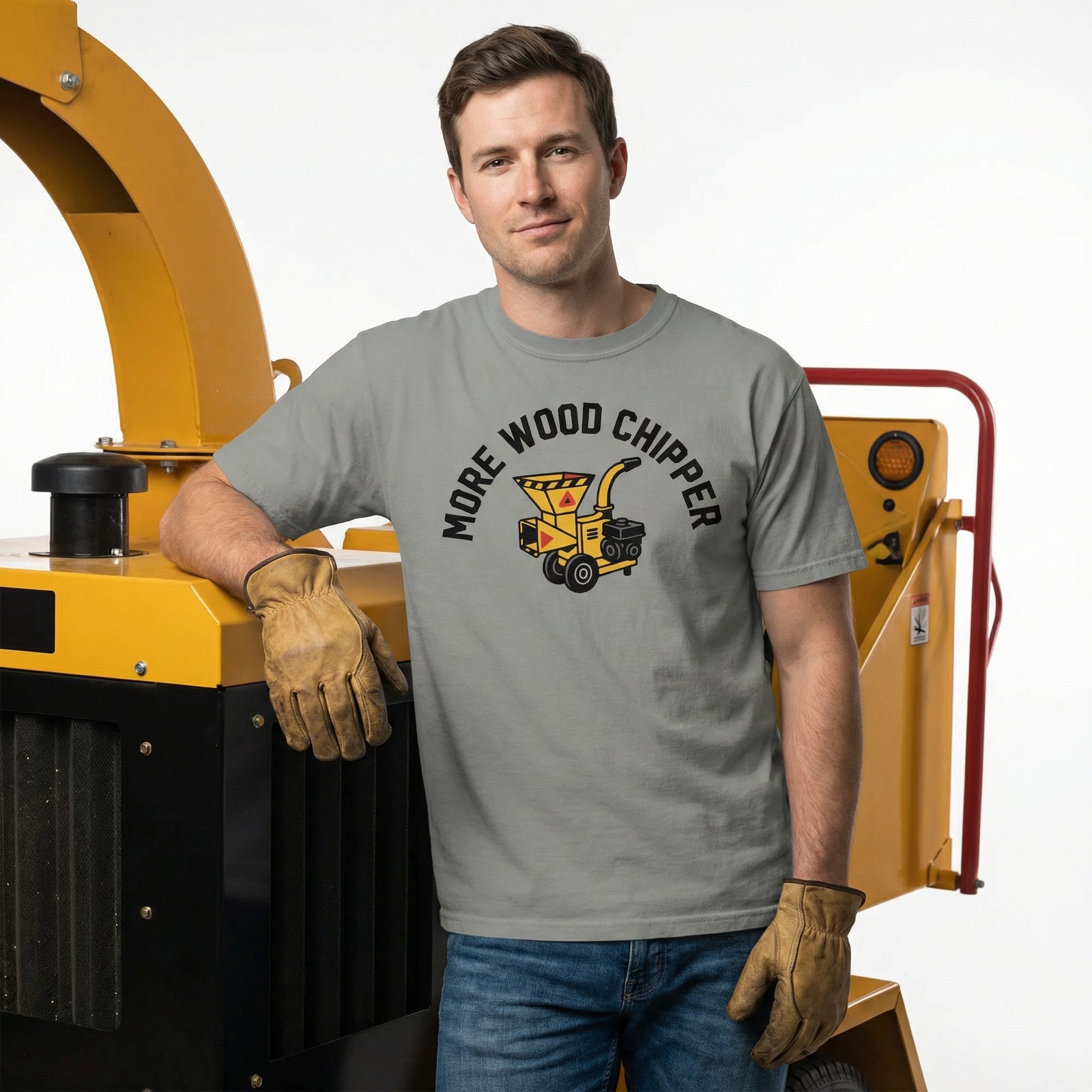 Man wearing a t-shirt with a wood chipper graphic and text, standing next to a yellow machine.
