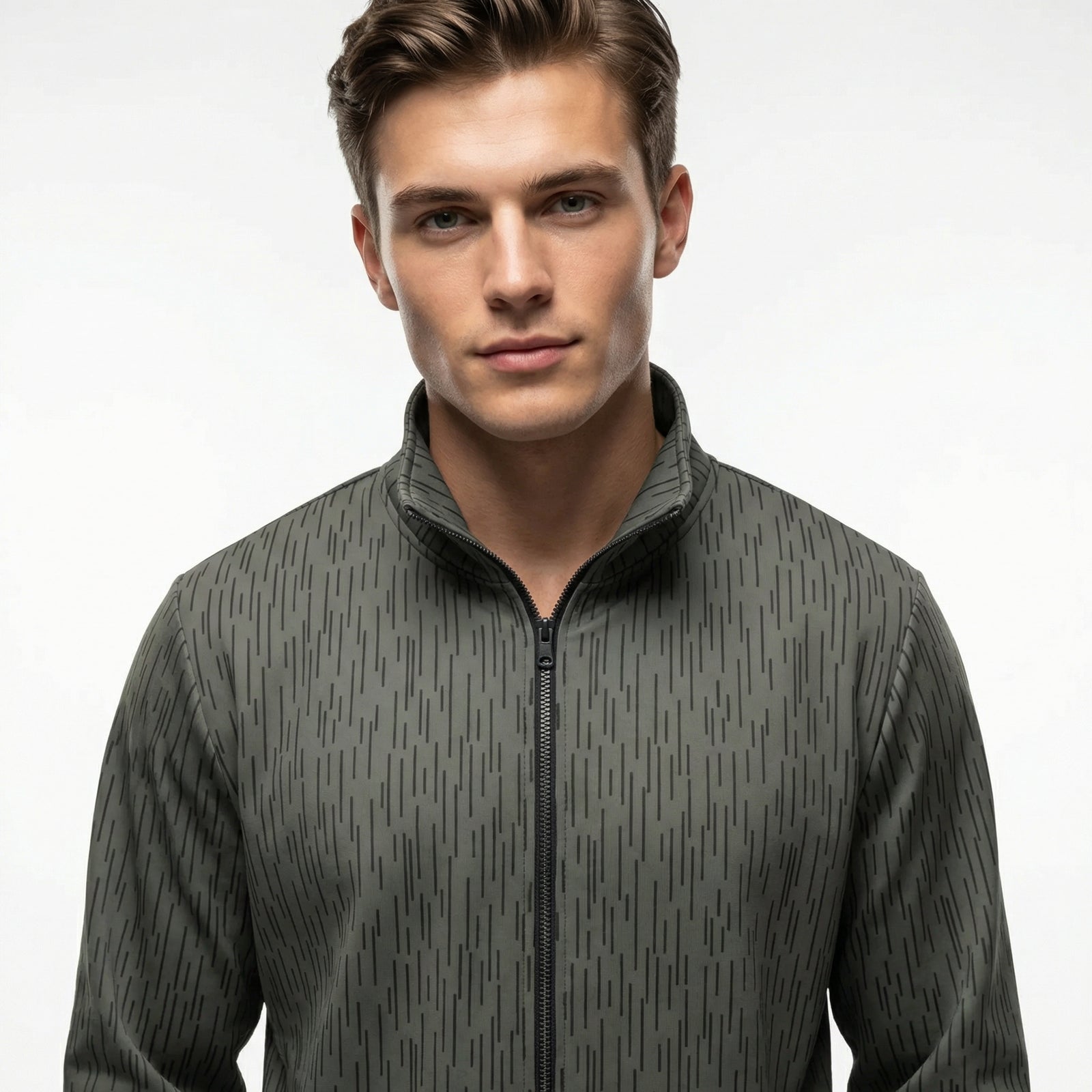 Man wearing a gray patterned Strichtarn Raindrop Camo Track Jacket on a white background