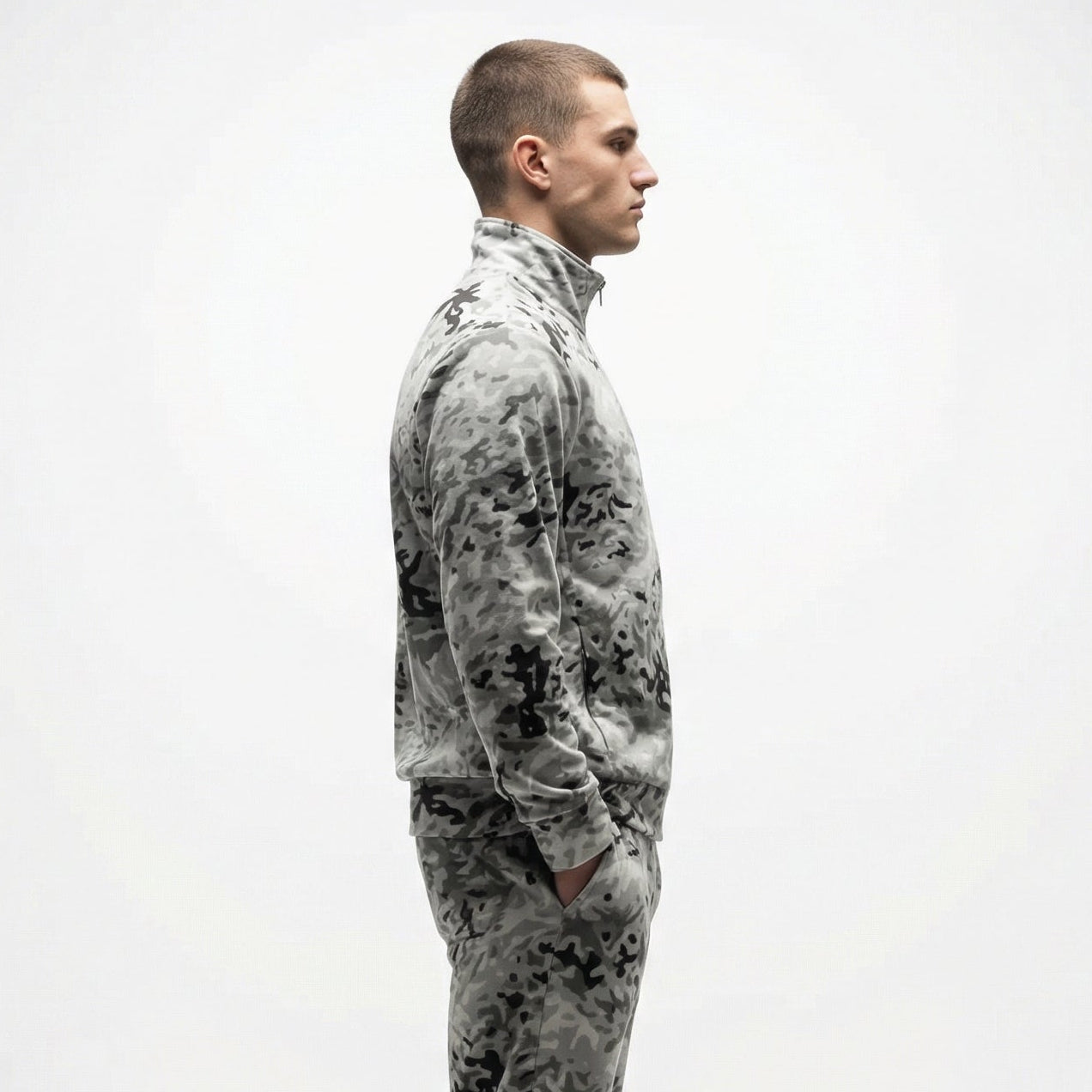 Person wearing a camouflage jumpsuit on a white background