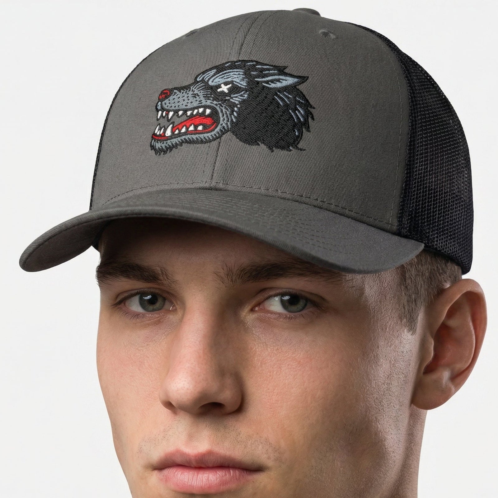 Man wearing a gray cap with a wolf logo on a white background
