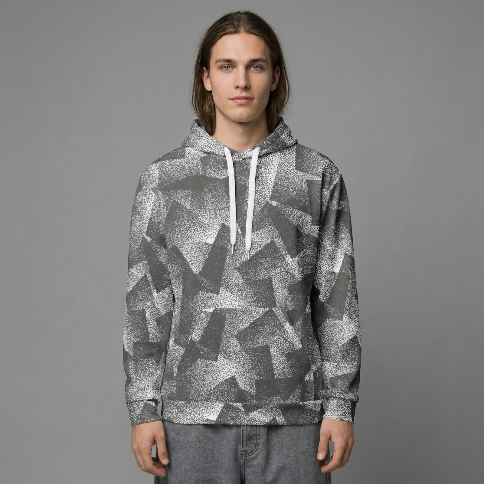 Person wearing a gray patterned hoodie against a gray background