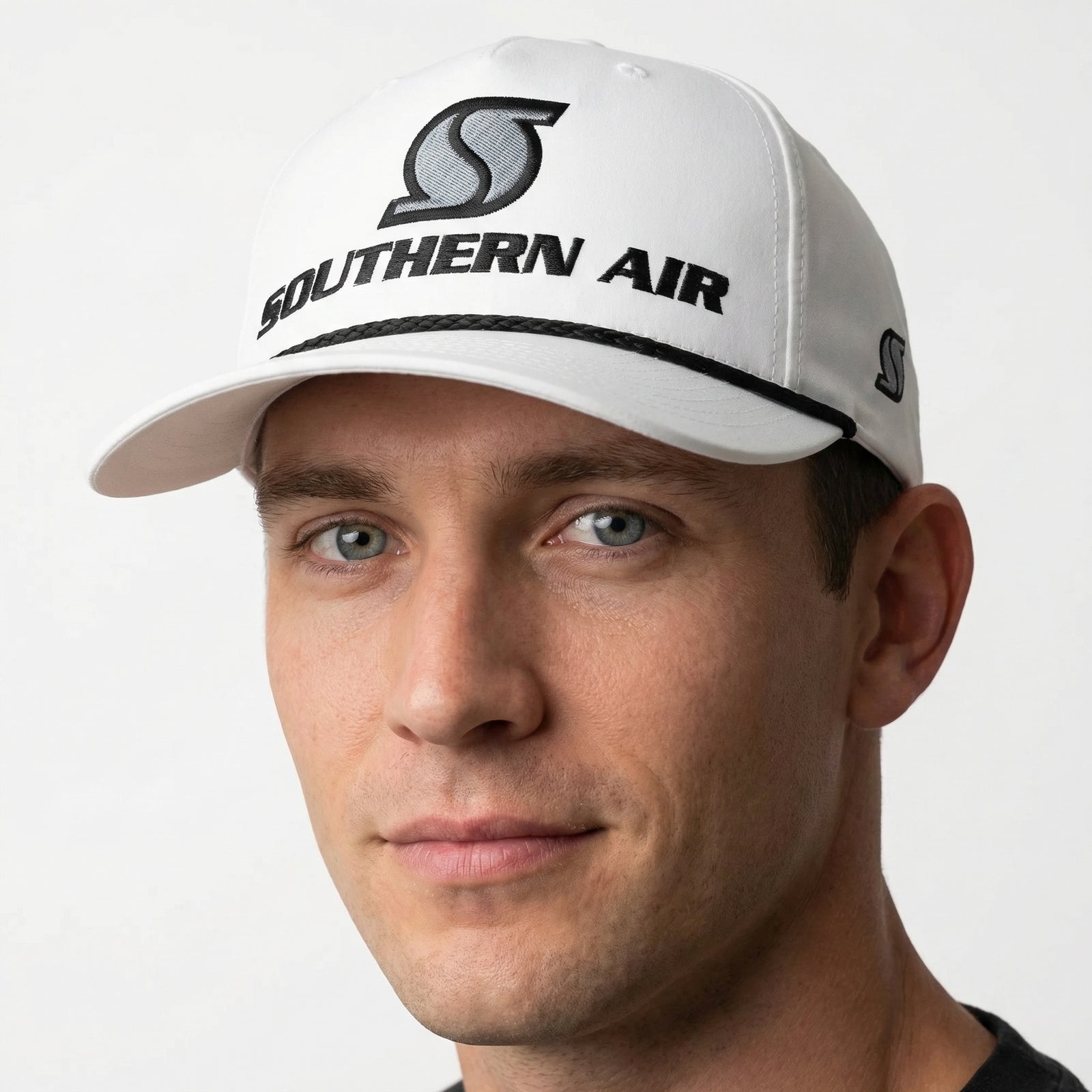 Man wearing a white cap with 'Southern Air' logo on a light gray background