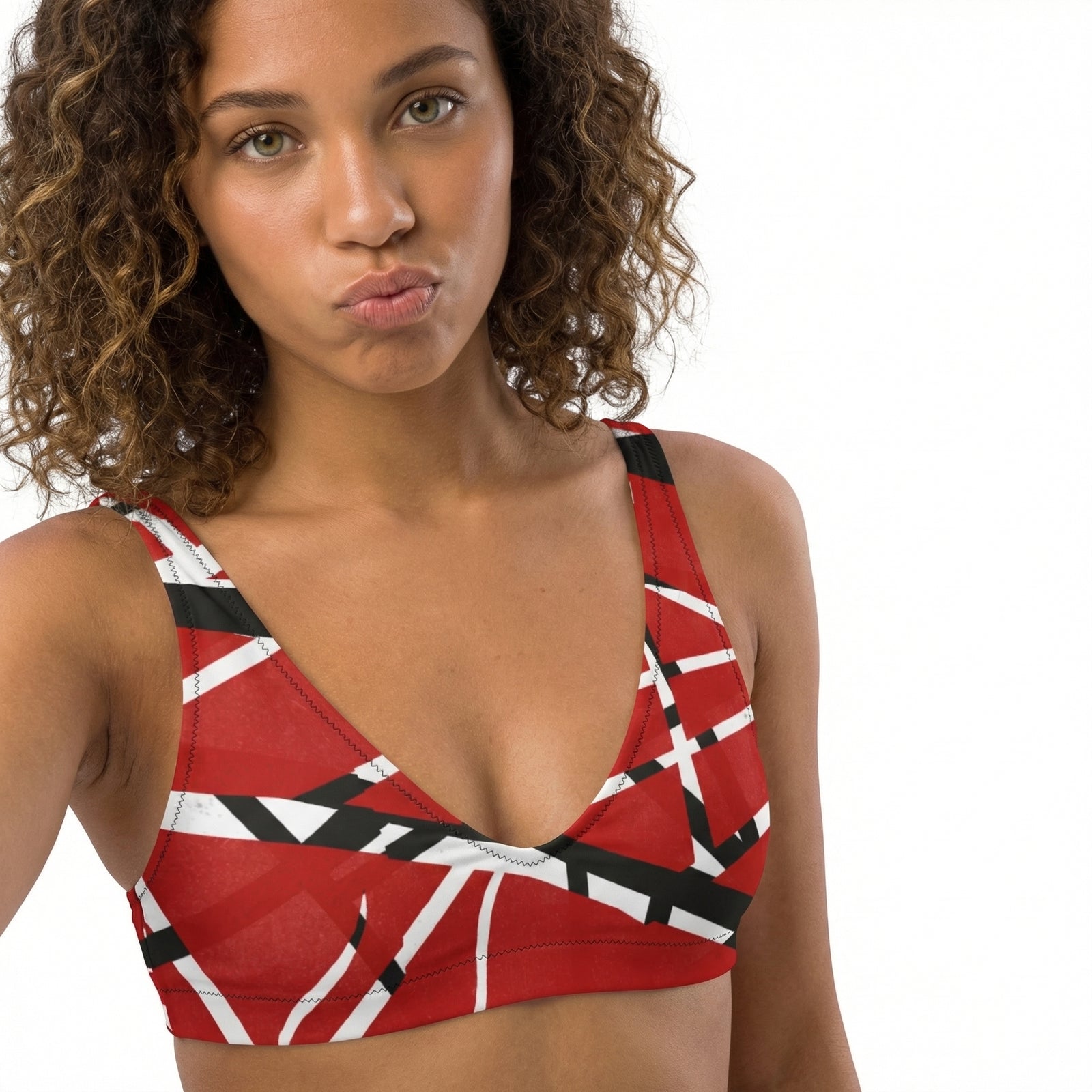 Woman wearing a red and black patterned top on a white background