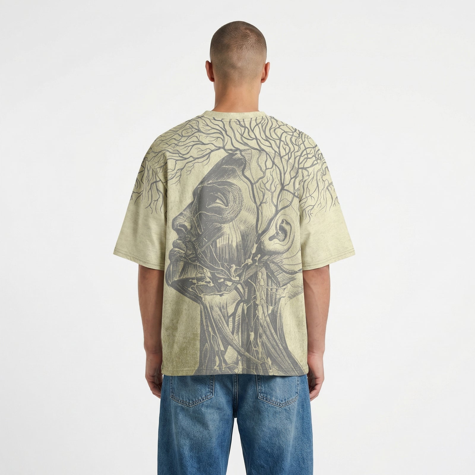 Person wearing a t-shirt with a graphic design on the back, standing against a plain background