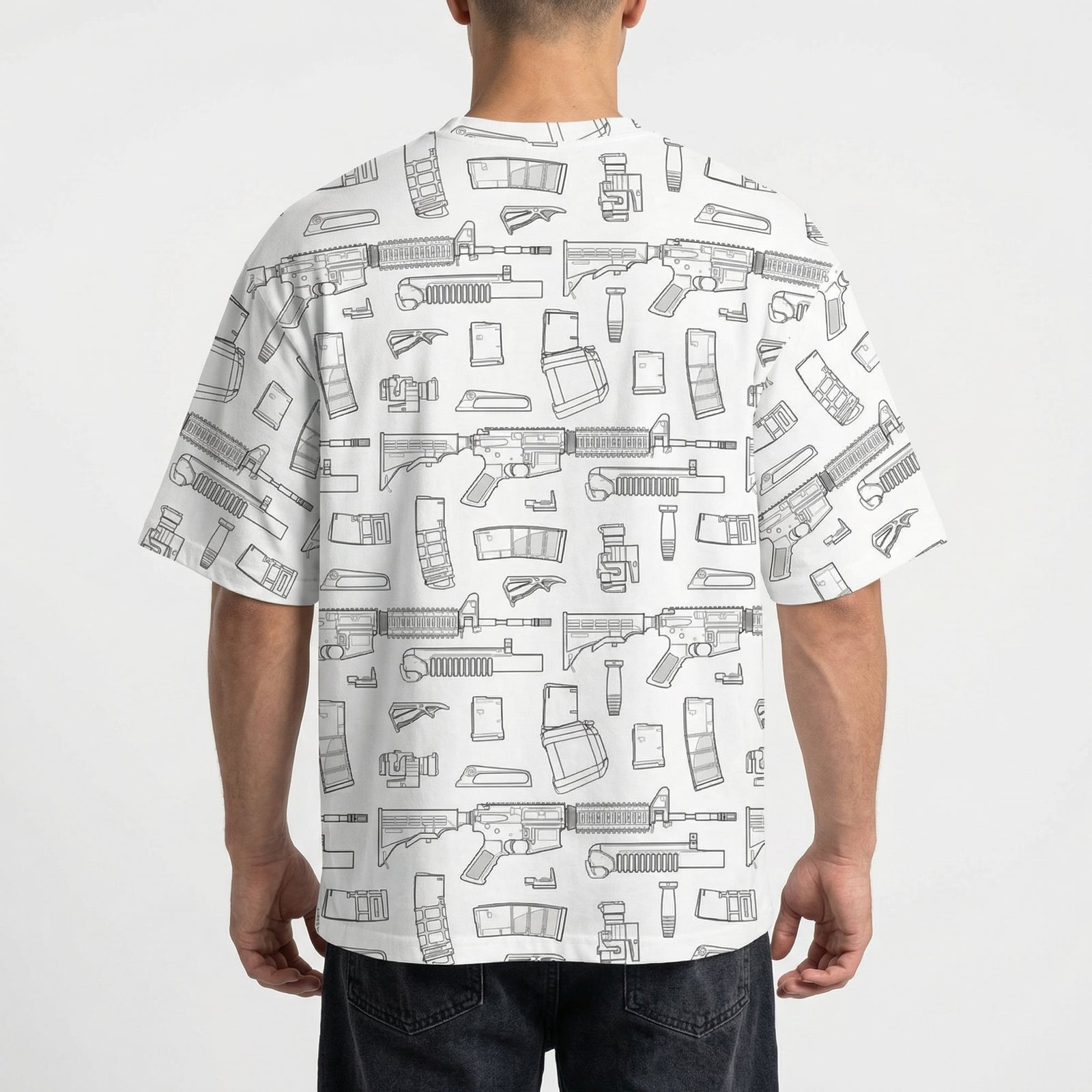 Person wearing a white t-shirt with black line art patterns on a plain background