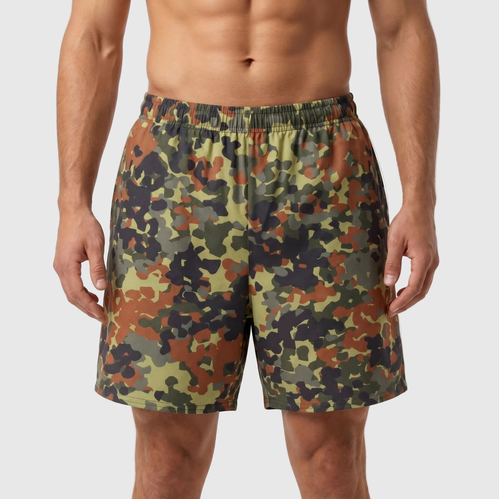 Camouflage shorts worn by a person on a white background