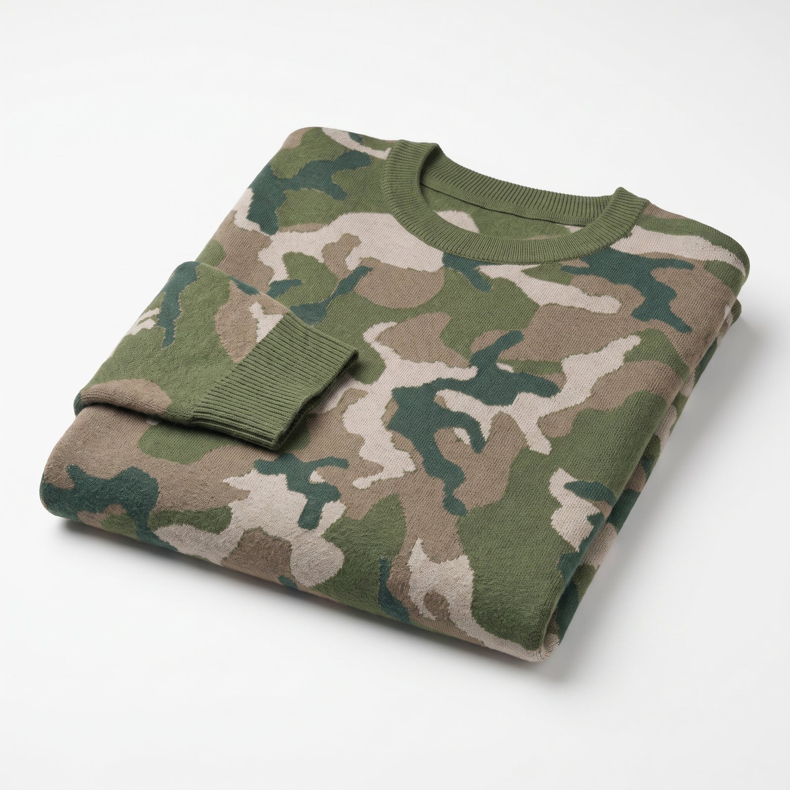Folded camouflage sweater on a white background