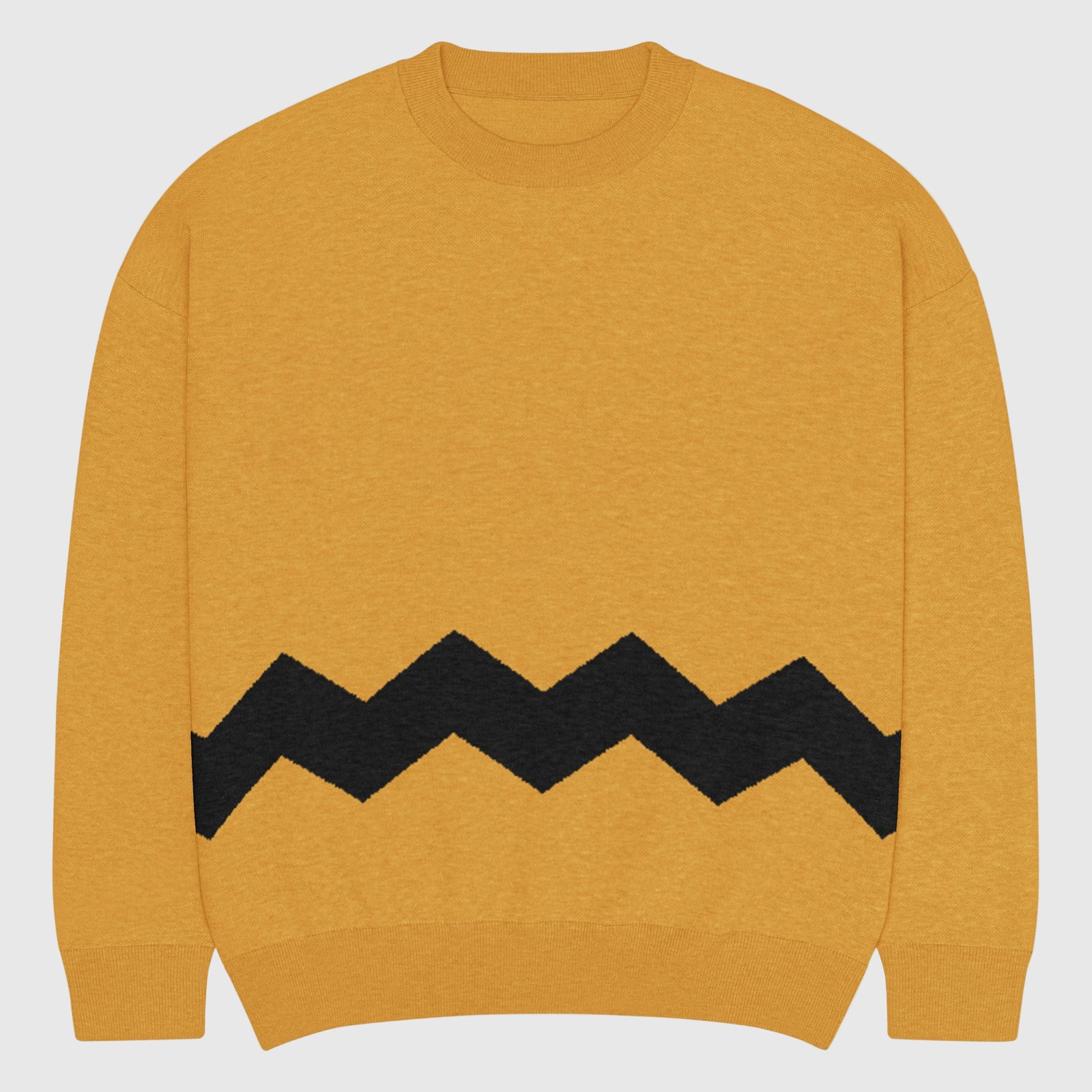 Yellow sweater with black zigzag pattern on a light gray background