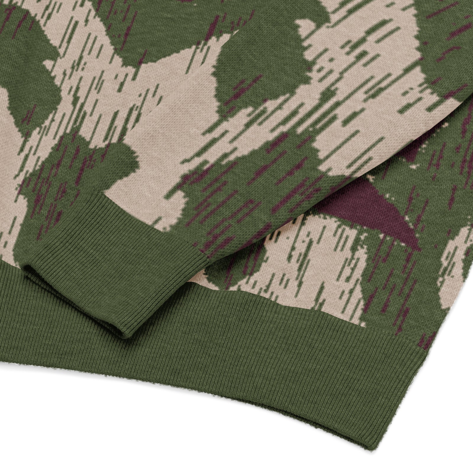 Close-up of a green camouflage fabric with a pattern of brown, green, and purple.