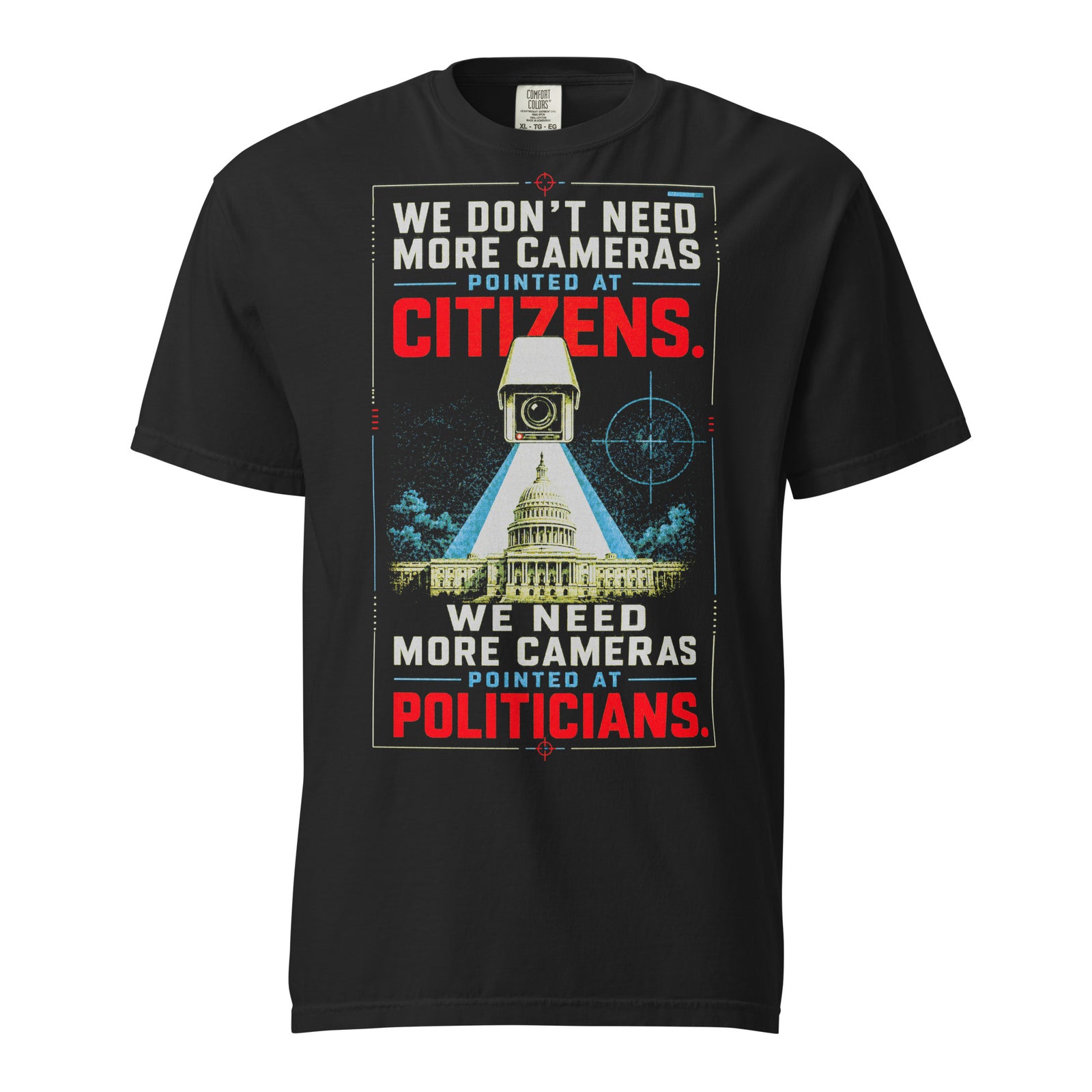 Cameras Pointed at Politicians Heavyweight Graphic Tee featuring a spy movie style surveillance camera aimed at the U.S. Capitol with bold red, cream, and blue typography on a black shirt.