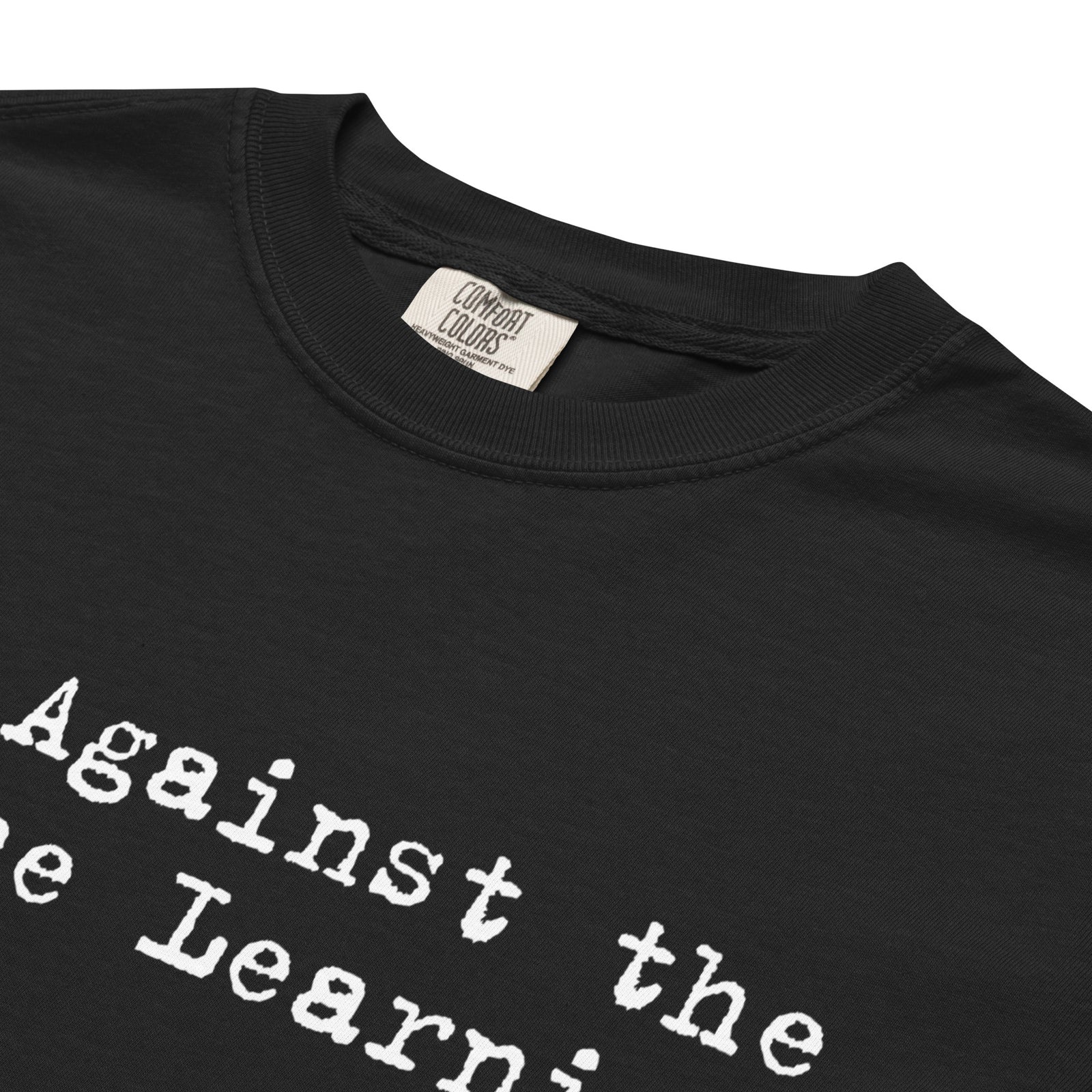 Close-up of the white typewriter-style Machine Learning print on black cotton