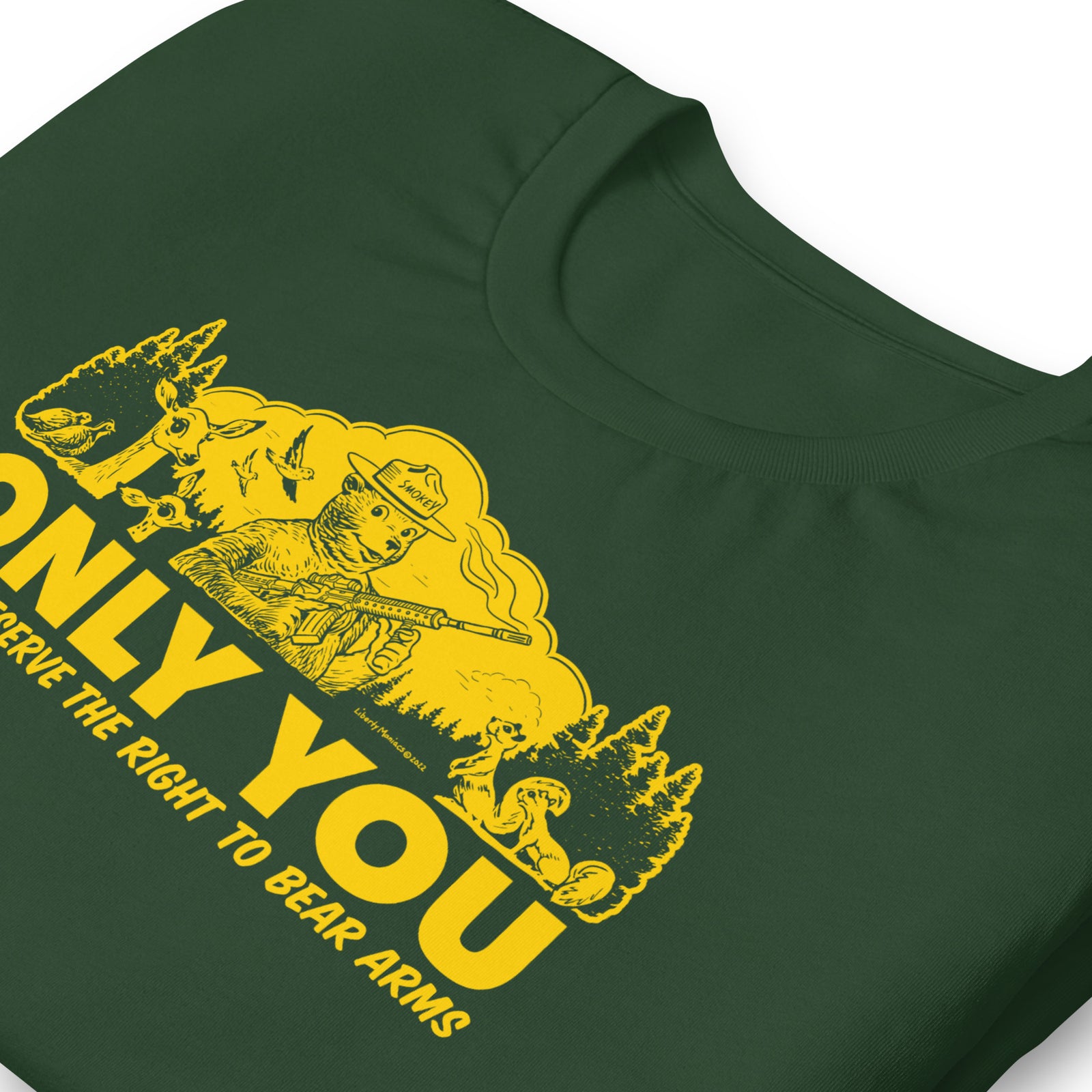 Close-up of the retro armed bear forest graphic printed on a forest green T-shirt