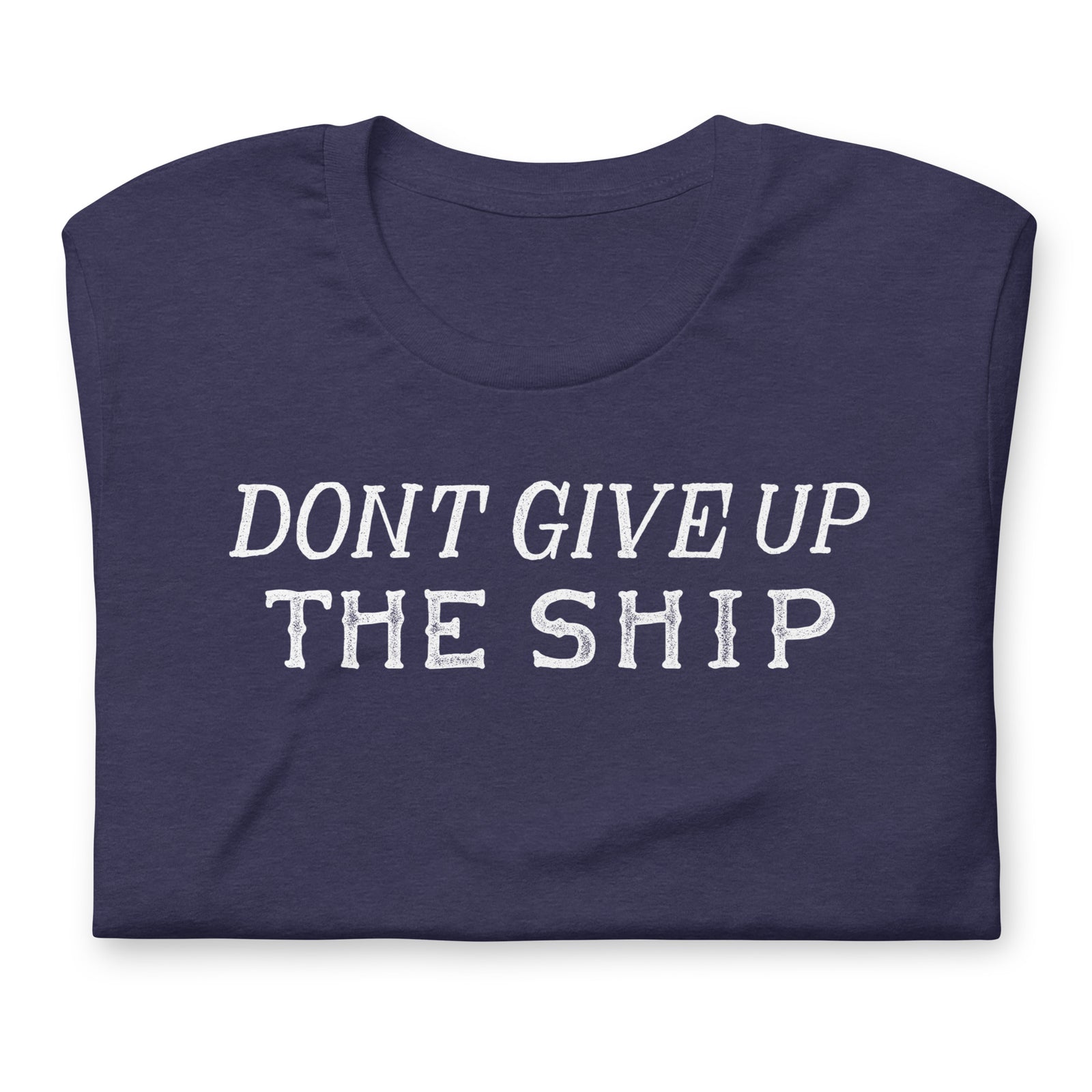 A navy blue folded t-shirt with the phrase 'DON'T GIVE UP THE SHIP' printed in distressed white capital letters across the chest, shown on a plain white background.