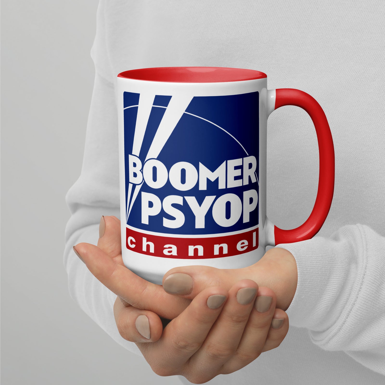 Mug with 'Boomer Psyop Channel' design held by a person against a plain background