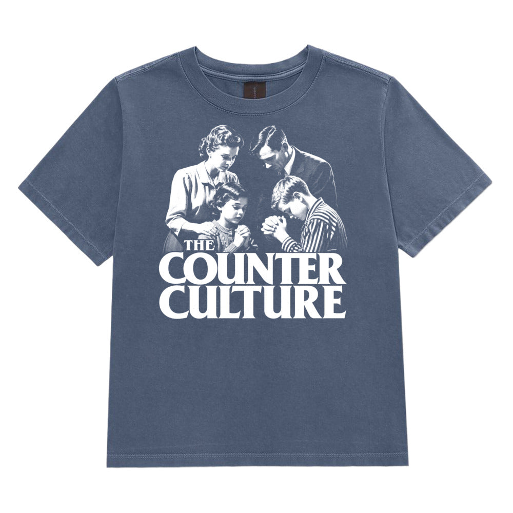 A faded slate blue short-sleeve t-shirt featuring a white graphic print of the band The Counter Culture with their classic album cover art, displayed flat against a solid white background.