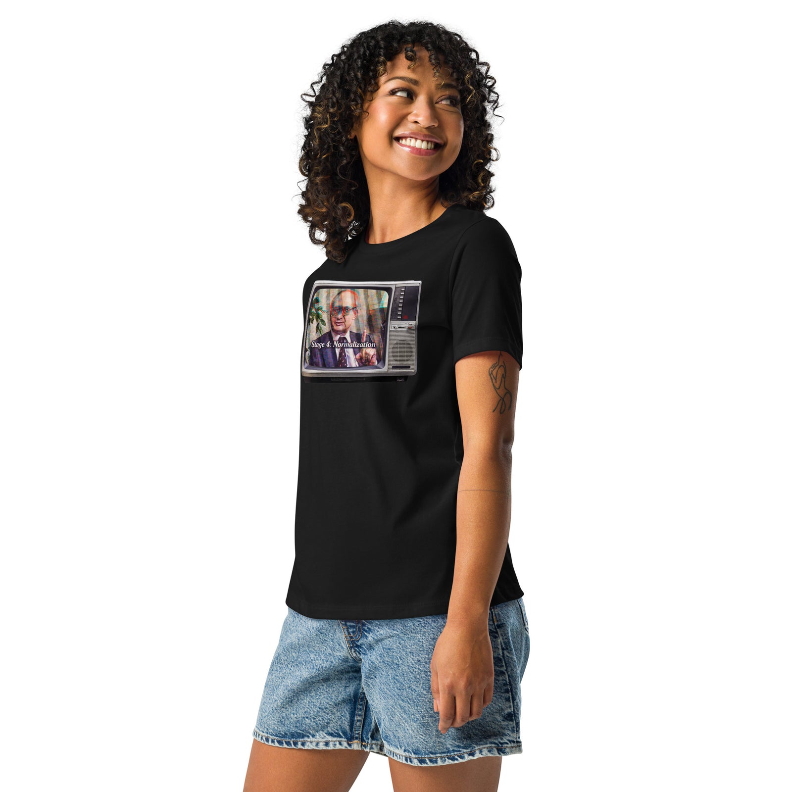 Woman wearing a black Yuri Bezmenov television graphic tee with denim shorts